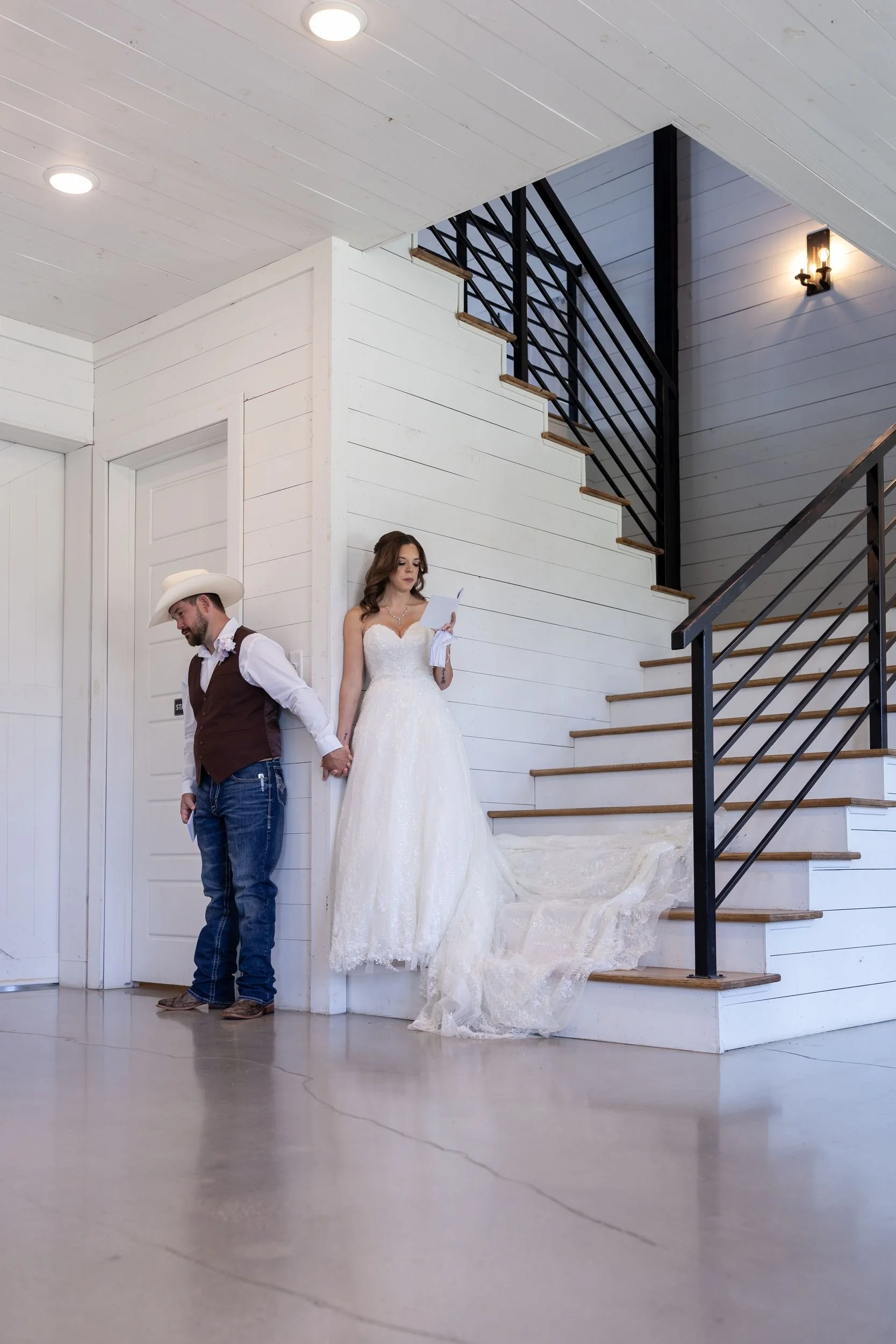 Heather and Geffrey by the black staircase inside The Barn at Paradise Place