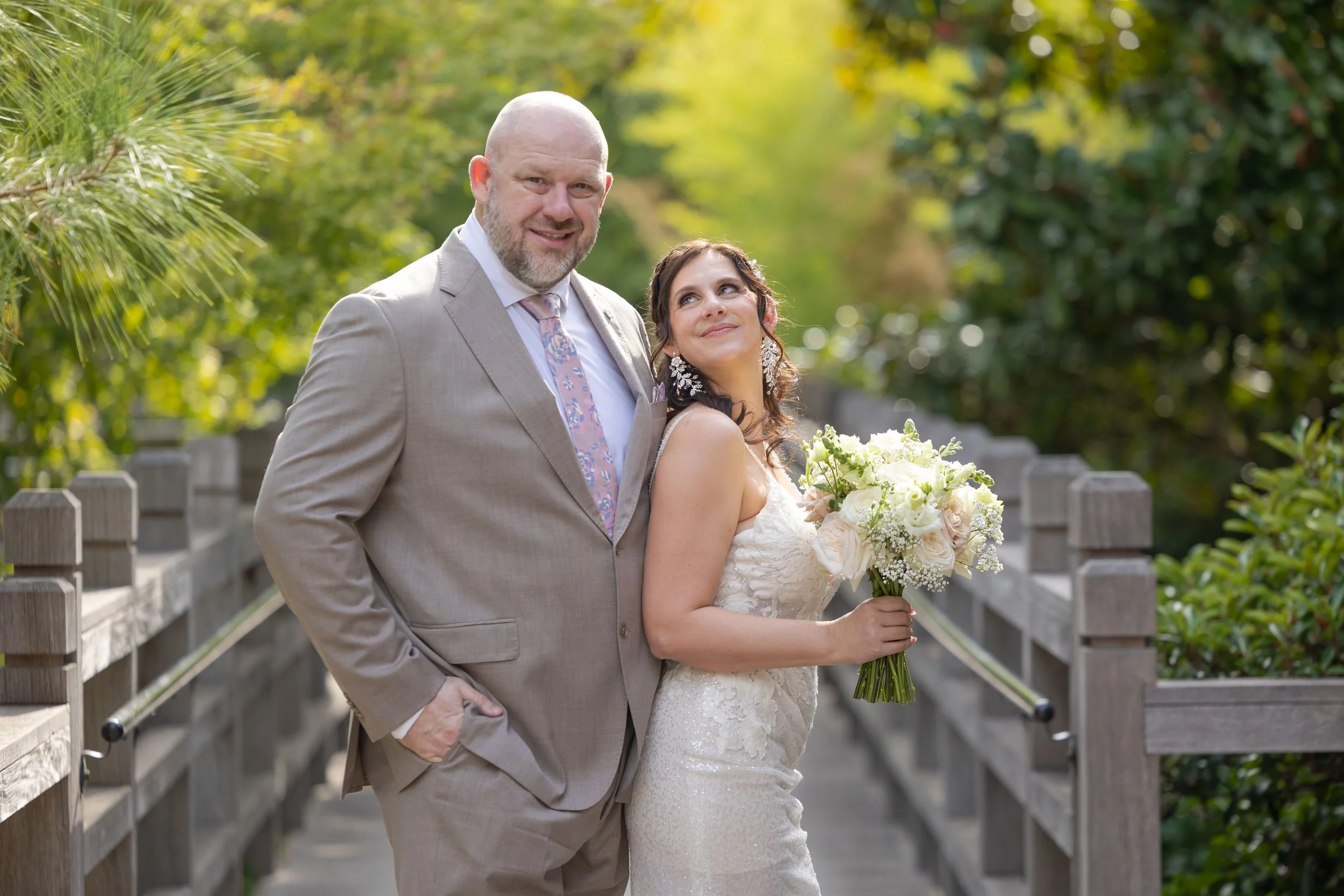 Lydia and Ryan smiling together during wedding portraits at the Fort Worth Botanic Garden