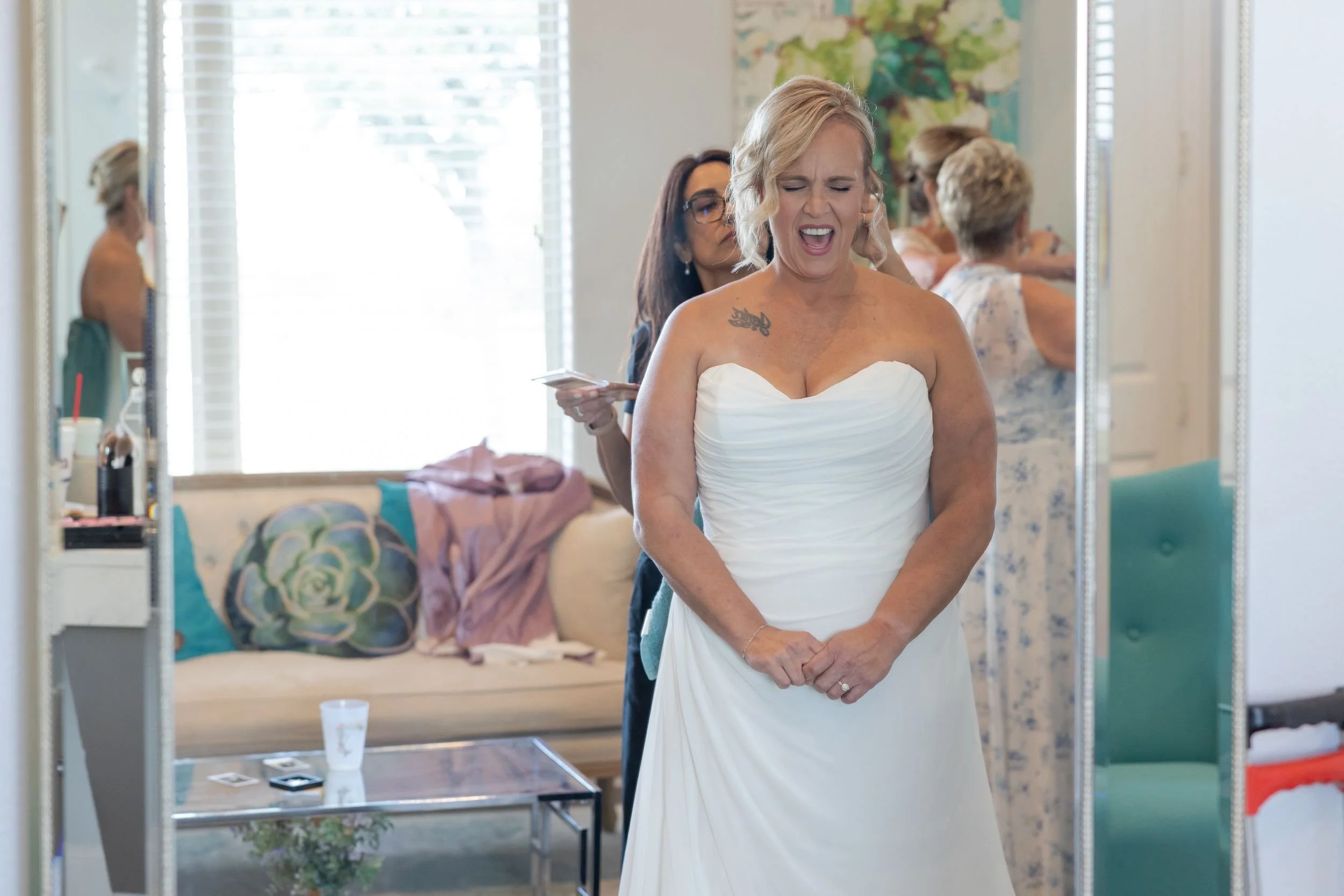 Lacey smiling in her strapless gown in the bridal suite at Dove Ridge Vineyard