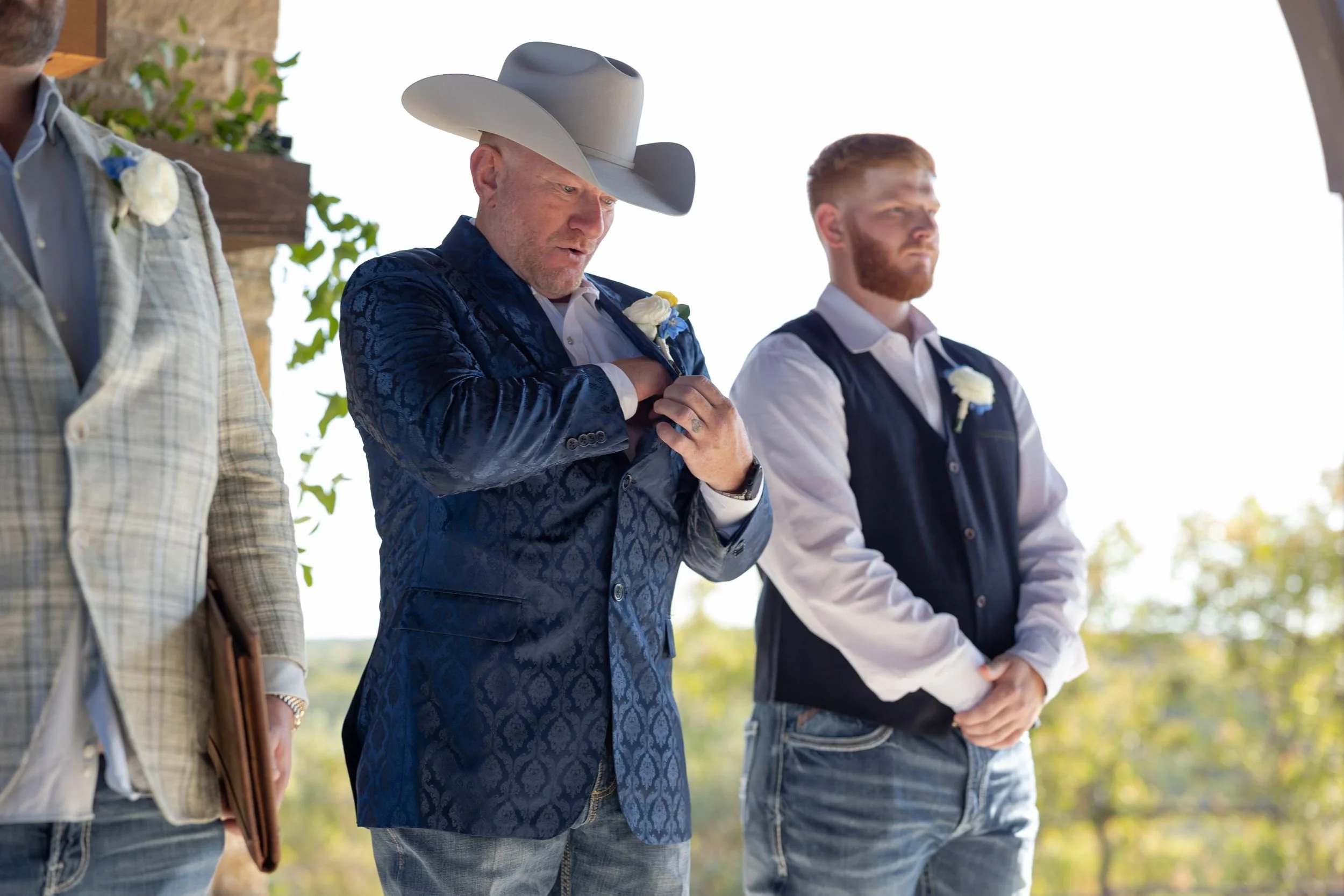 Jason waiting at the altar in a cowboy hat with his groomsmen