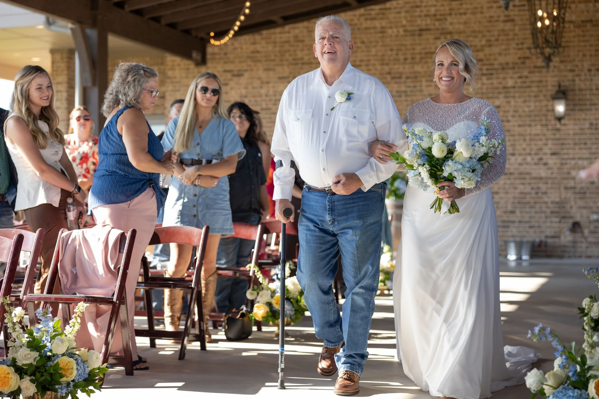 Lacey walking down the aisle with her father at Dove Ridge Vineyard
