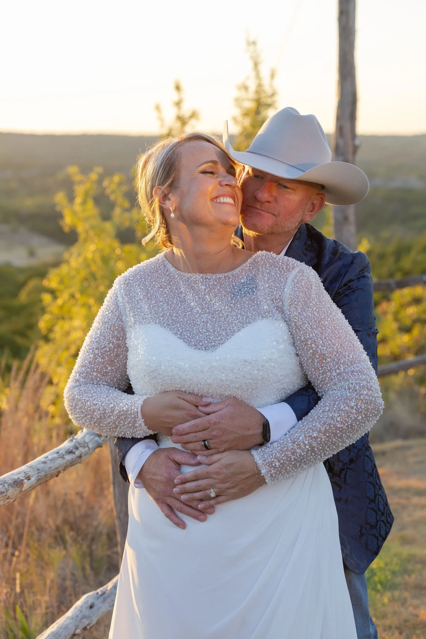 Lacey and Jason embracing at sunset at Dove Ridge Vineyard in Weatherford, Texas