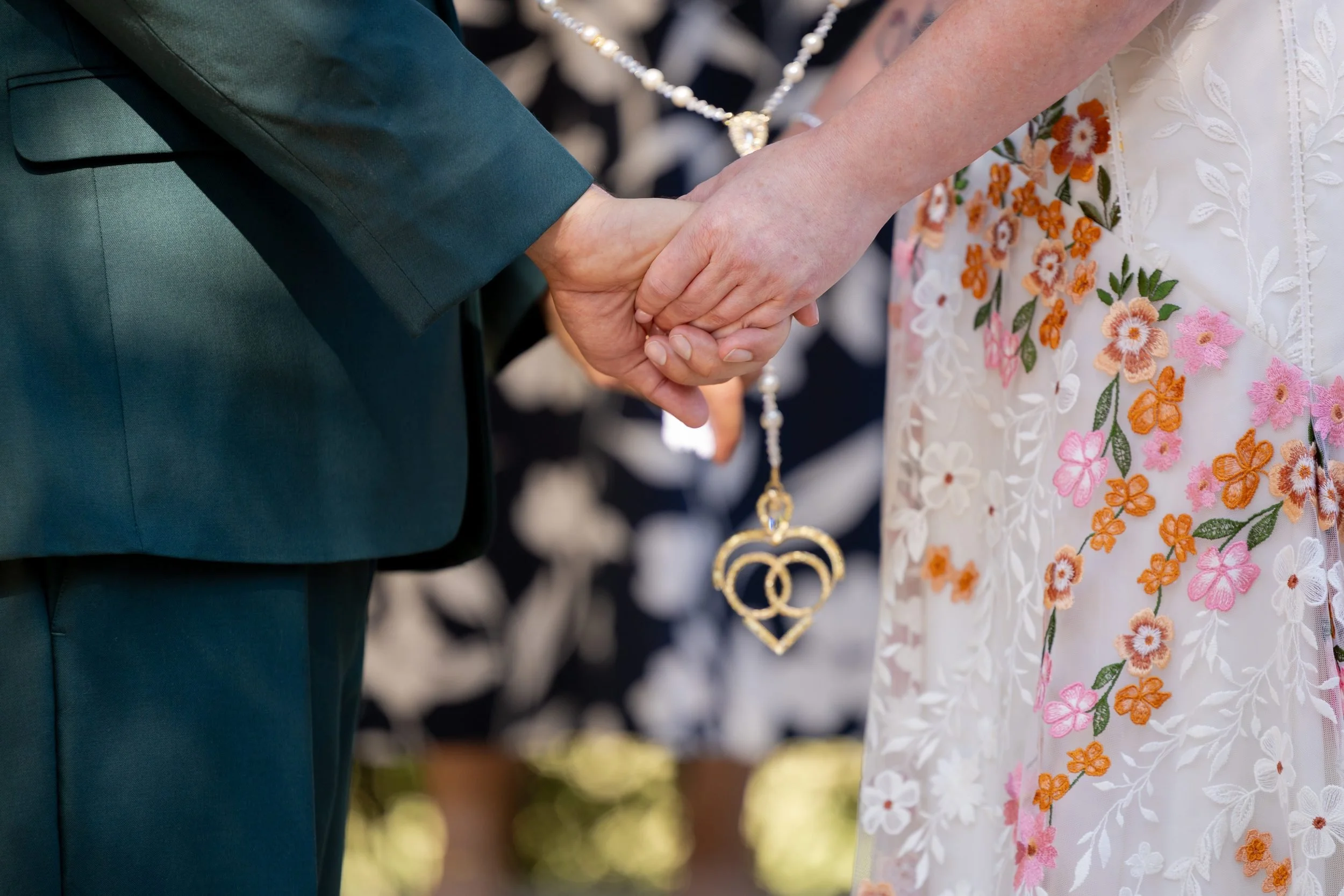 Close-up of the bride and groom's hands exchanging rings at The Orchard