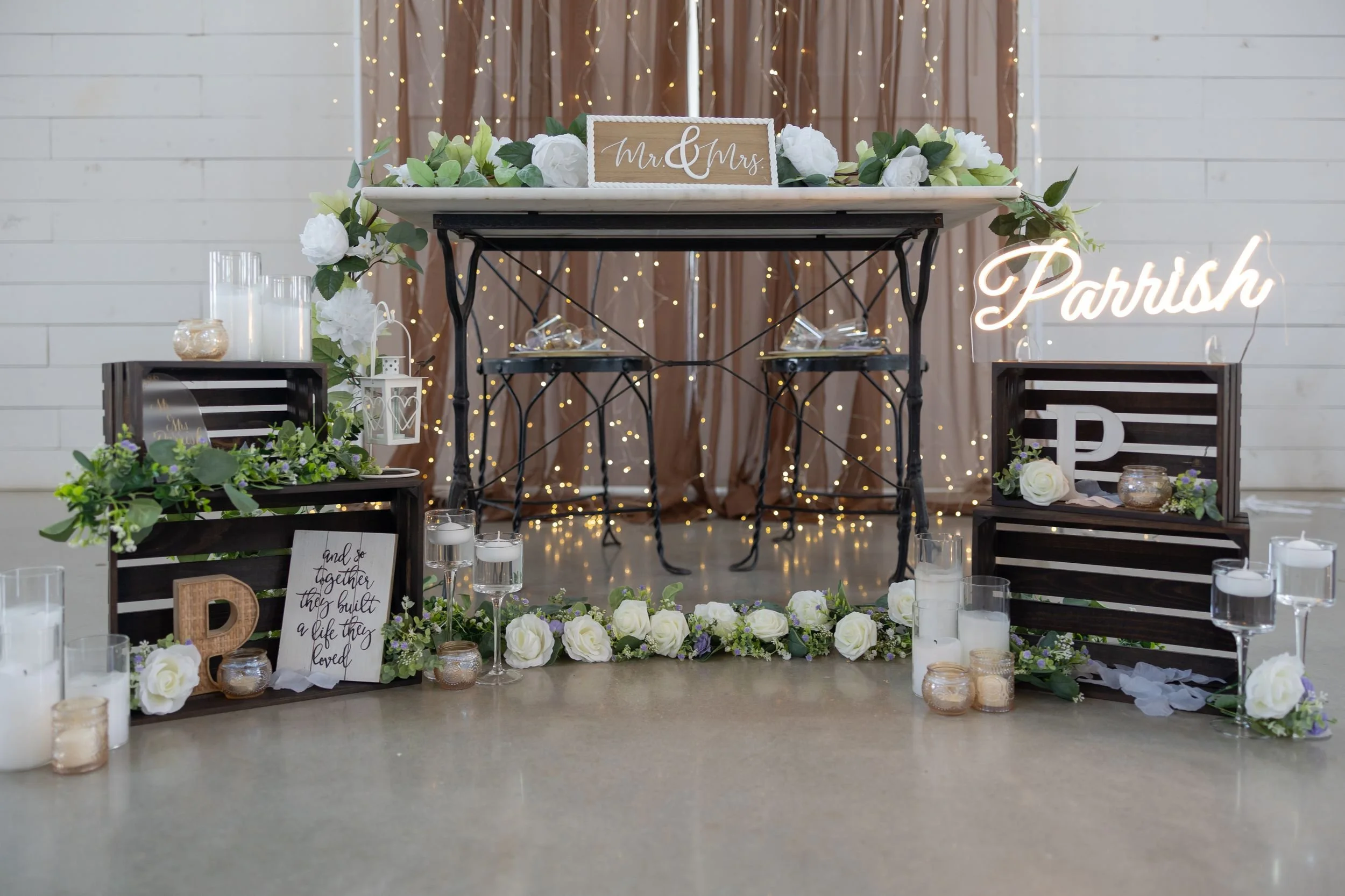 Rustic welcome display with greenery at The Barn at Paradise Place wedding venue