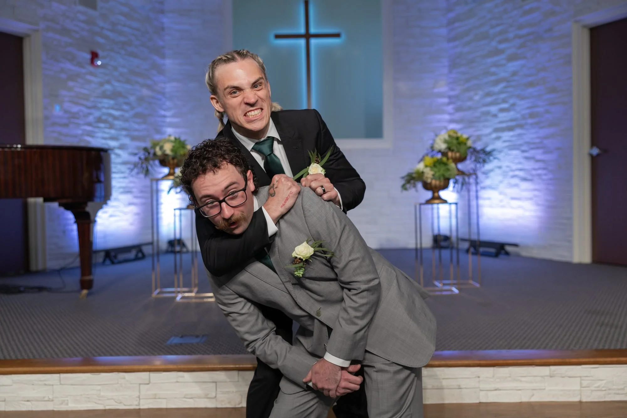 Groomsmen playfully wrestling in a chapel, a funny wedding photo from a Fort Worth wedding
