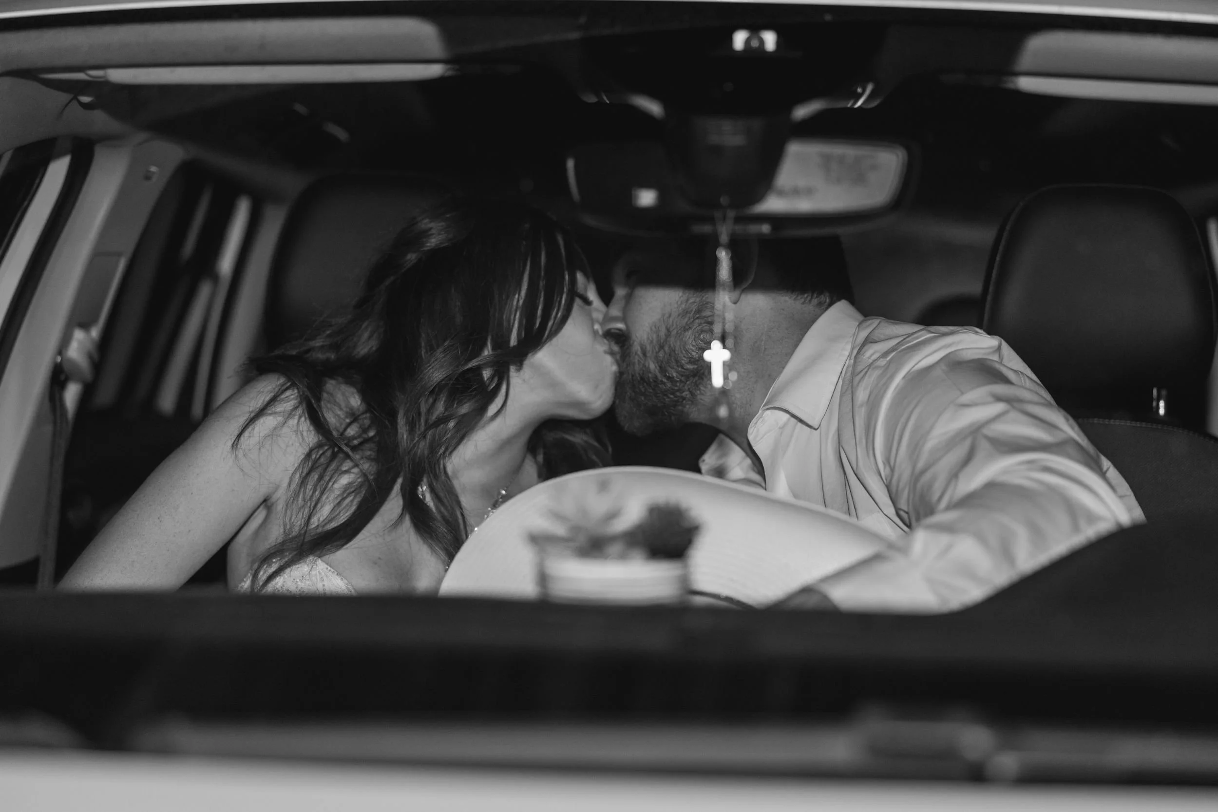 Black-and-white photo of Heather and Geffrey in their getaway car after the wedding