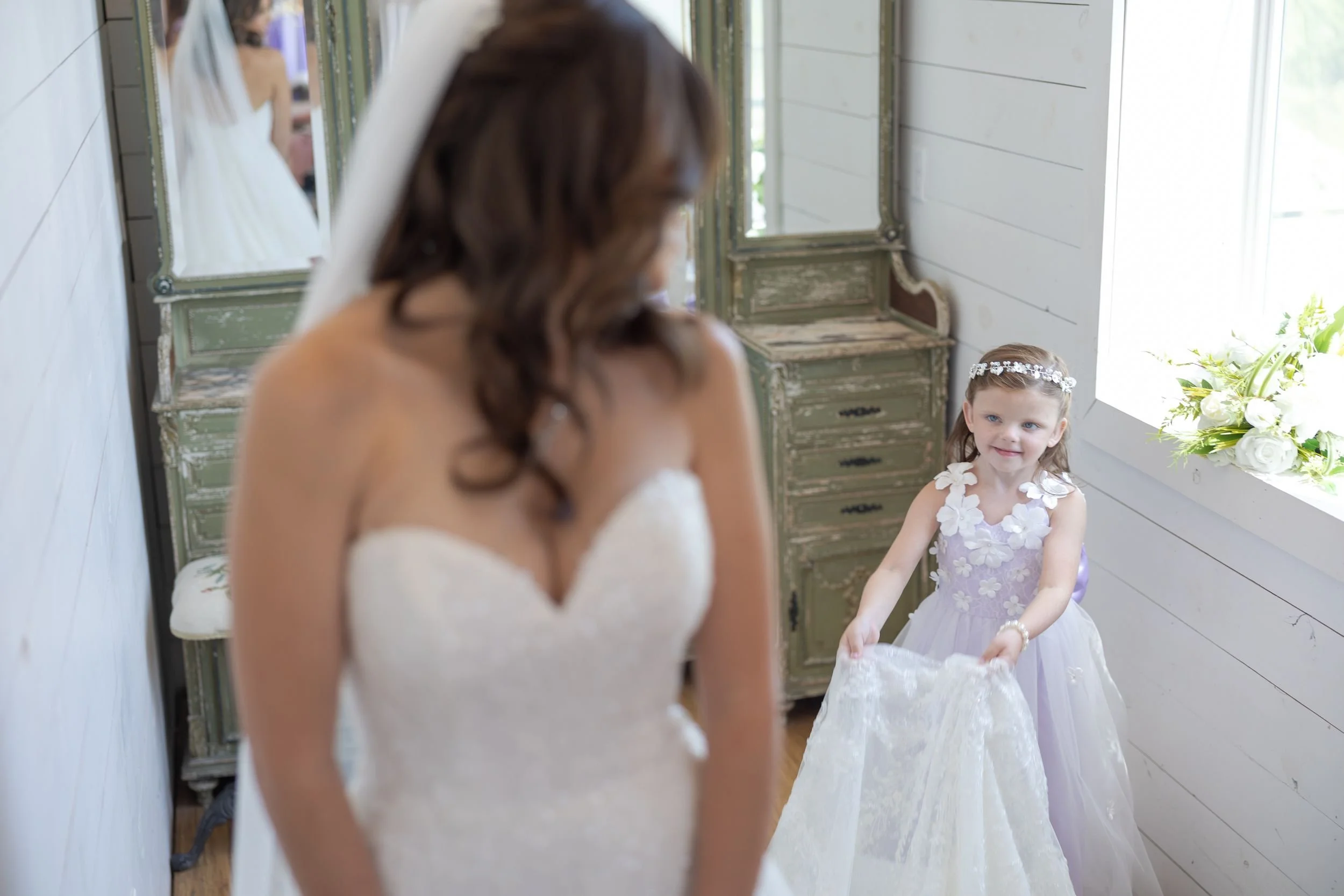 Bride sharing a moment with the flower girl while getting ready in Weatherford, Texas