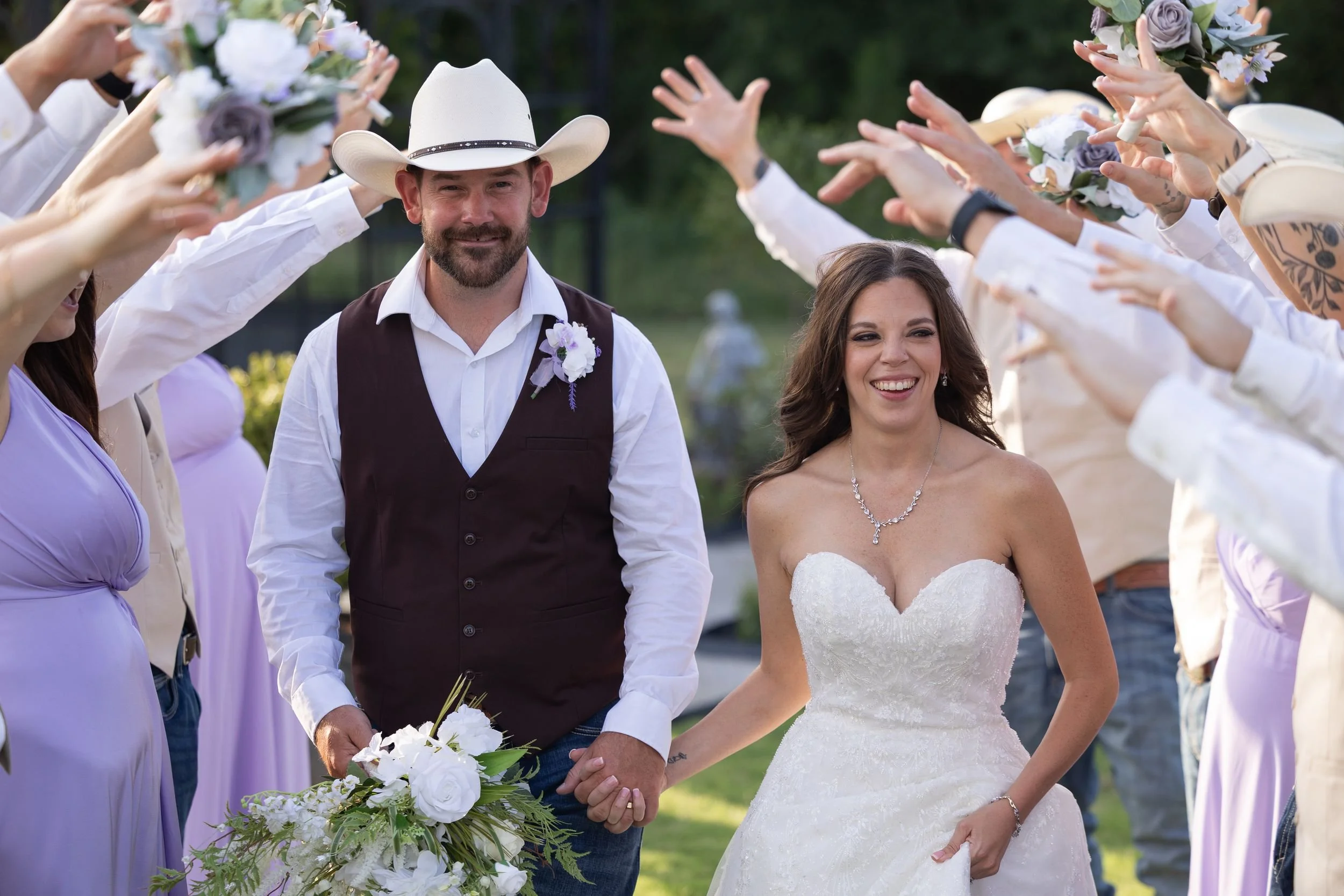 Heather and Geffrey walking out to cheering guests after their Weatherford wedding ceremony