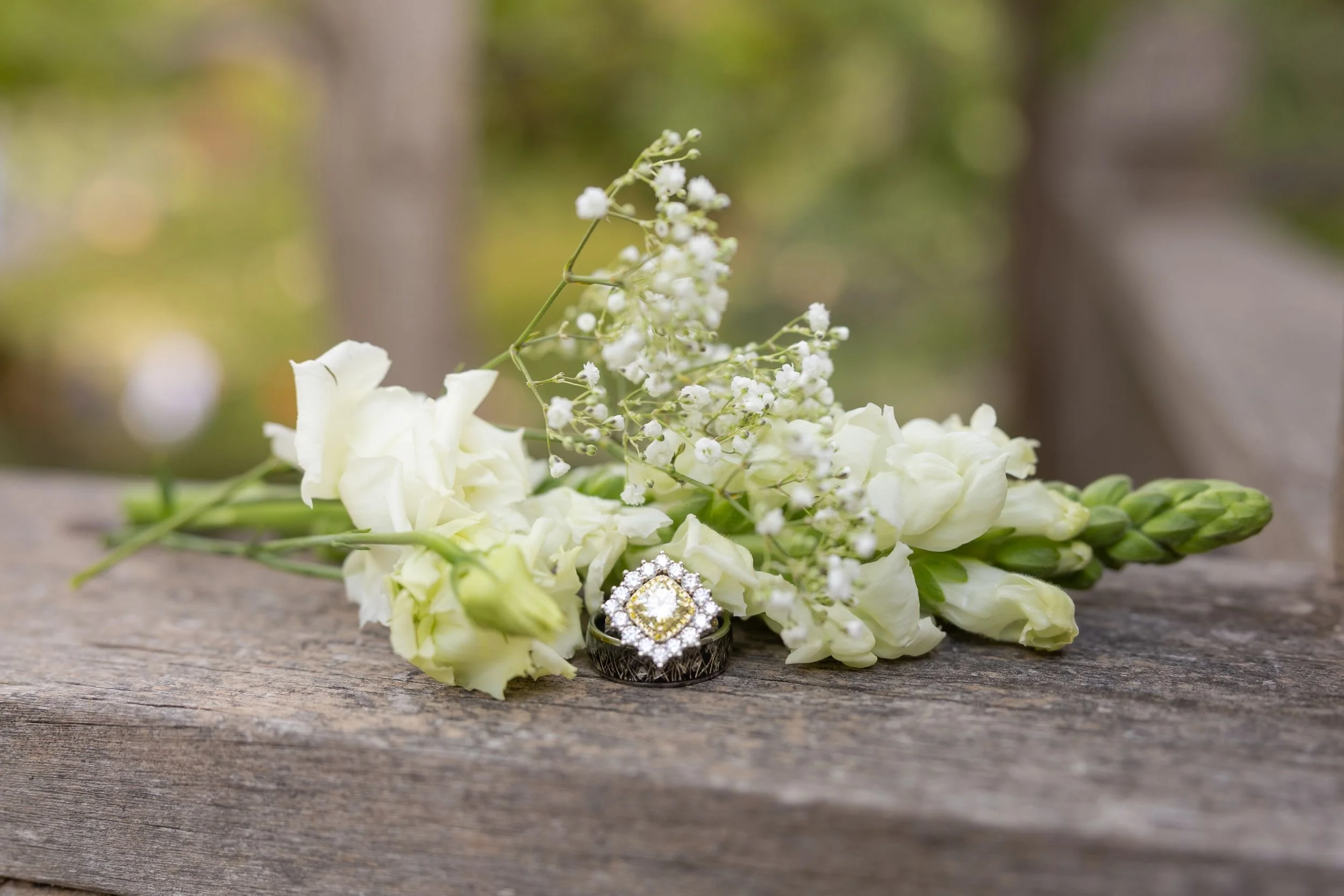 White rose bridal bouquet by Woodsy Floral resting on a stone ledge in the Japanese Garden