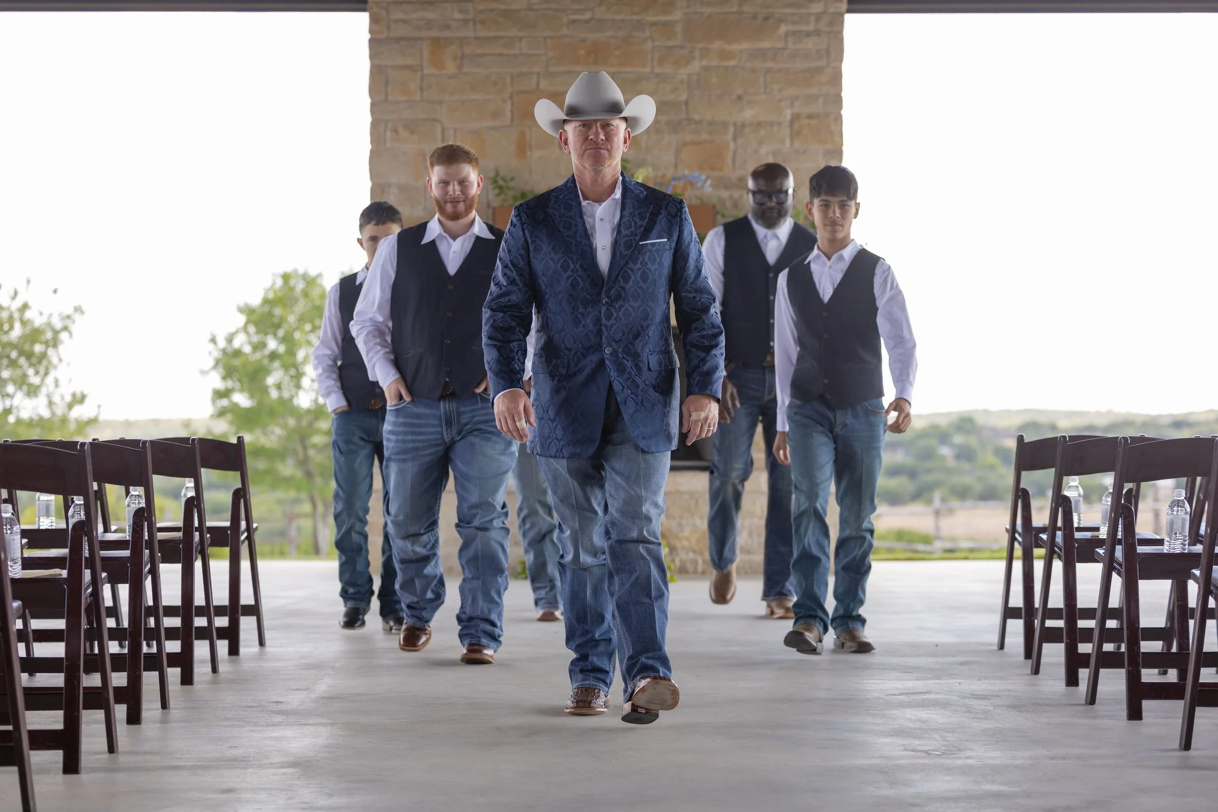 Groom and groomsmen walking across the patio at Dove Ridge Vineyard
