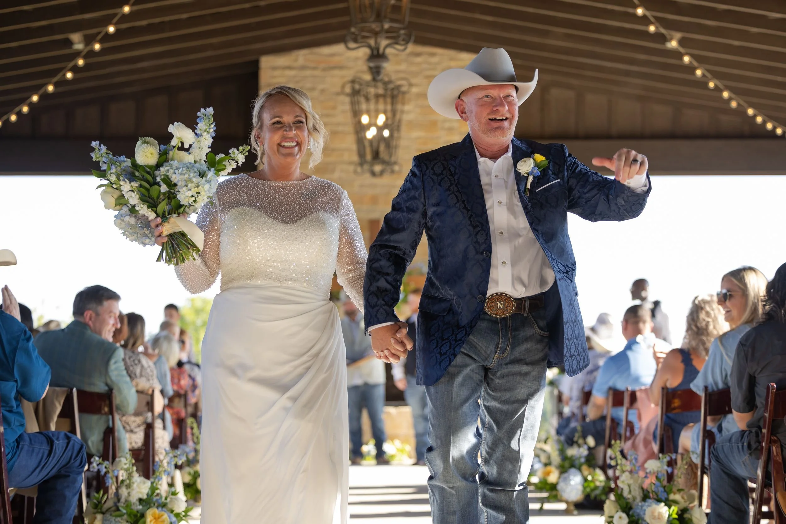 Lacey and Jason walking back down the aisle as newlyweds at Dove Ridge Vineyard