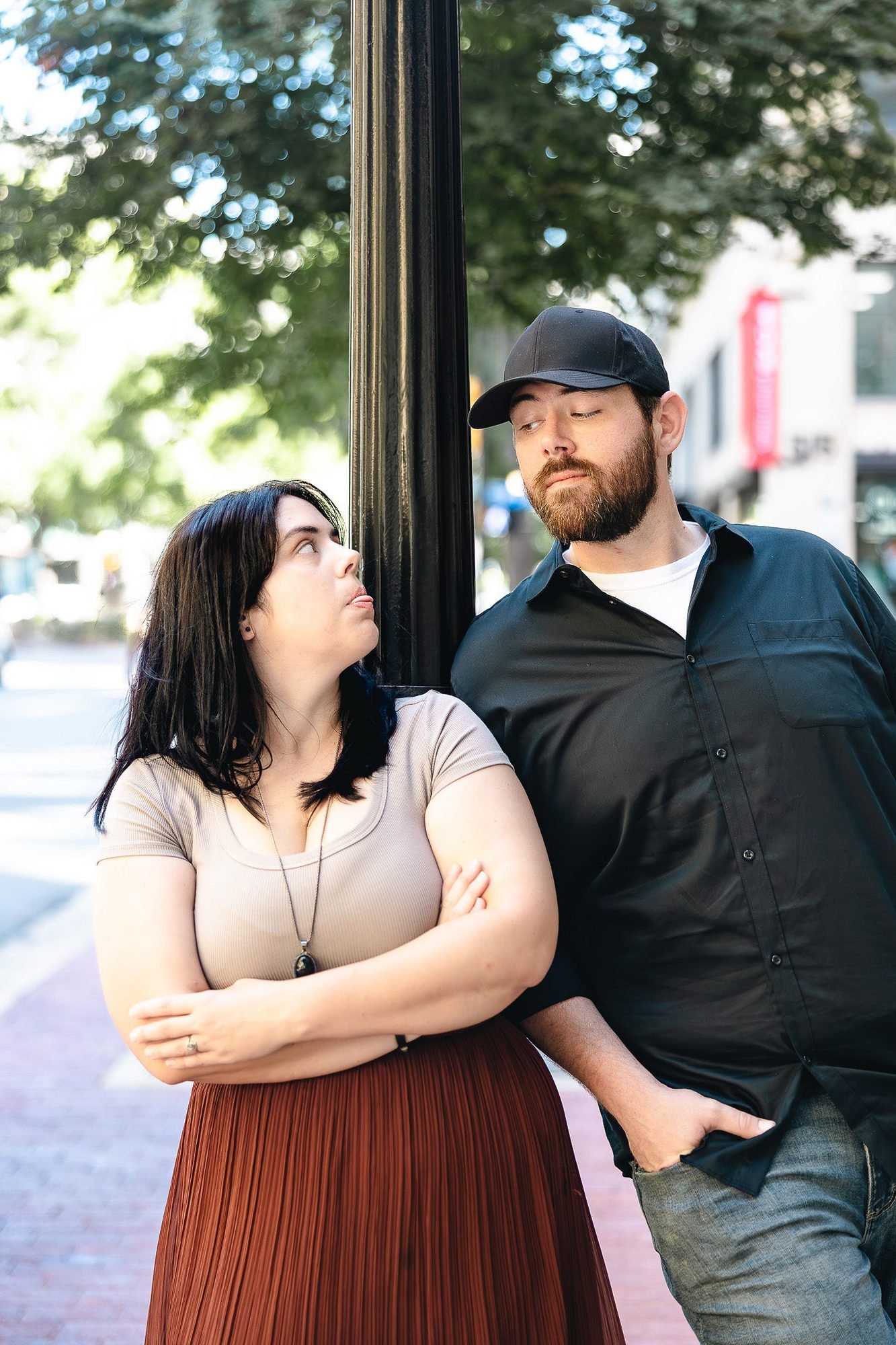 Dani and Jordan, a fun husband-and-wife wedding photography team in DFW, posing by a lamppost