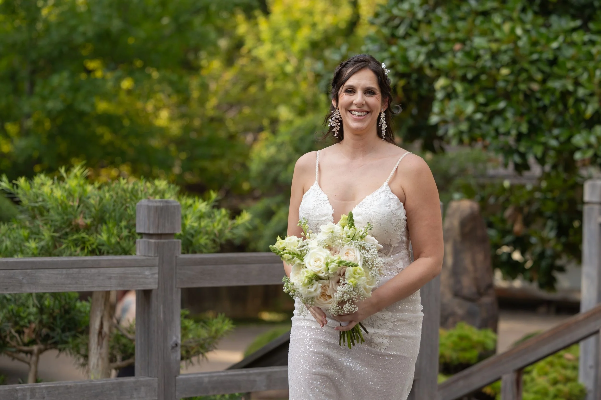 Bridal portrait with a white bouquet on a bridge at the Fort Worth Japanese Garden