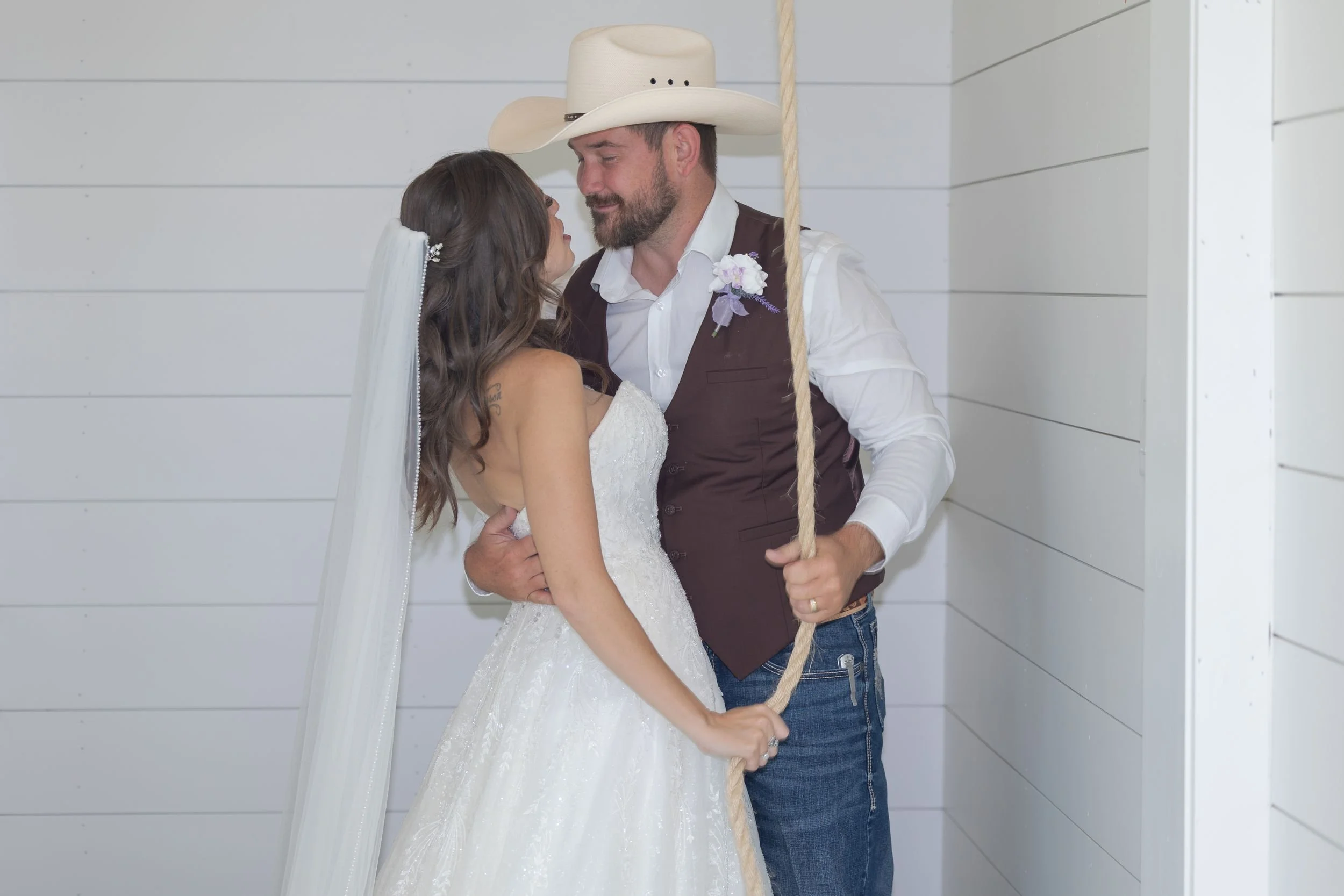 Bride and groom portrait against white shiplap walls at The Barn at Paradise Place