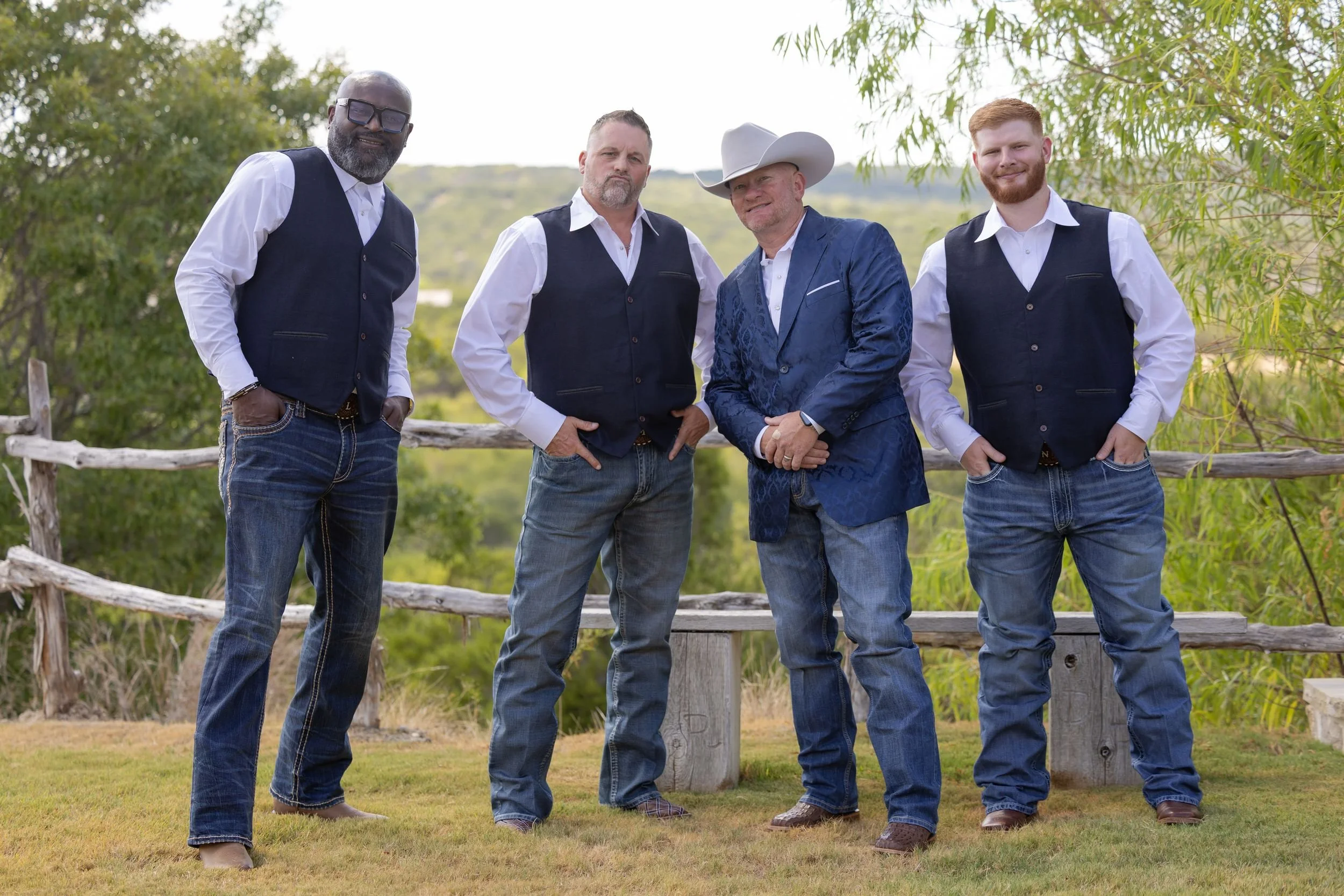 Groom and groomsmen in navy vests at Dove Ridge Vineyard in Weatherford