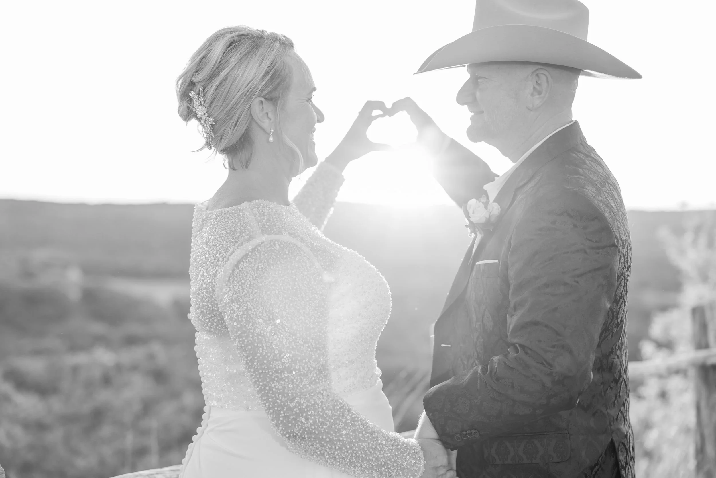 Black-and-white portrait of Lacey and Jason touching foreheads at Dove Ridge Vineyard