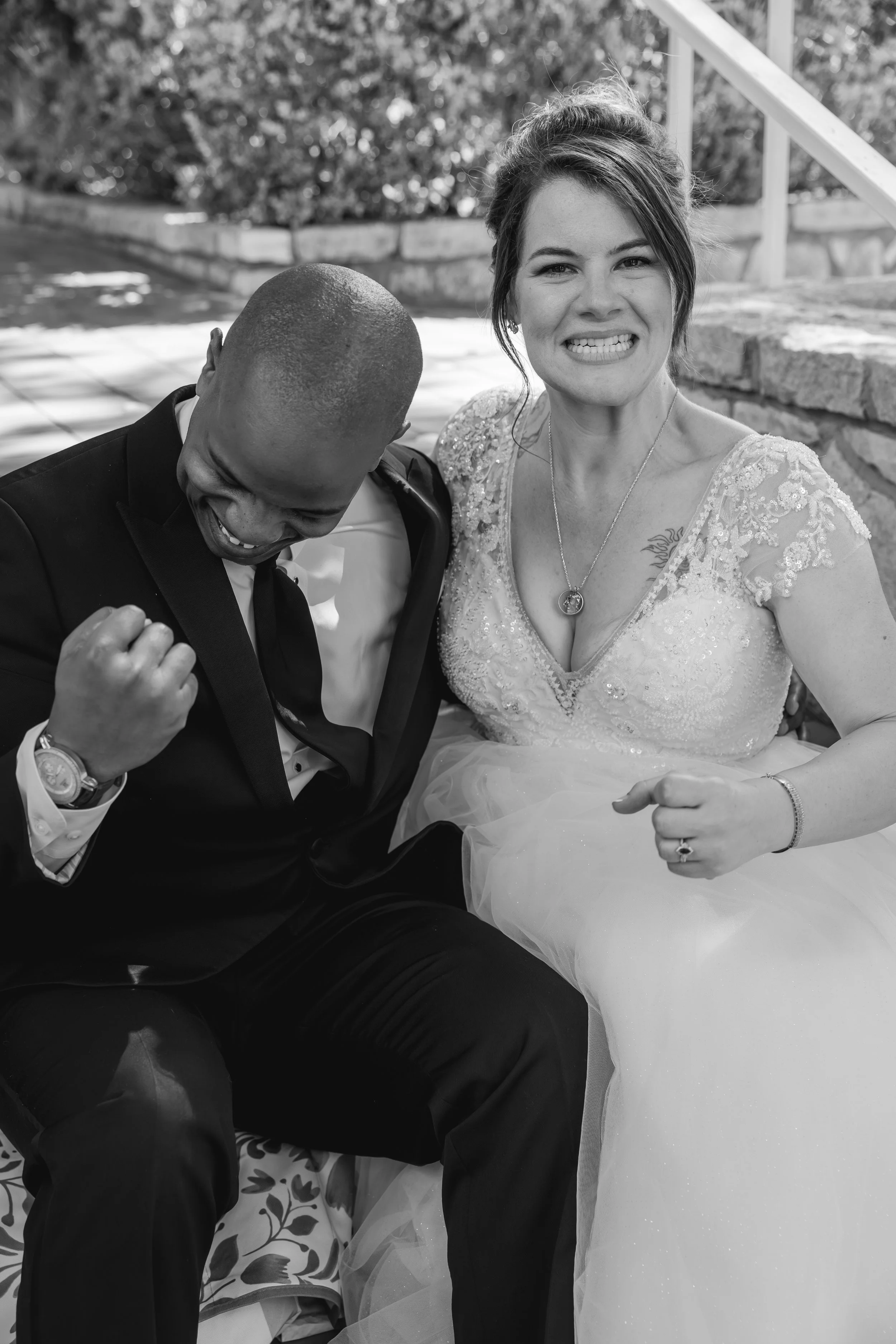 Black-and-white portrait of a laughing bride in a sequined gown with her groom, by Fort Worth wedding photographers