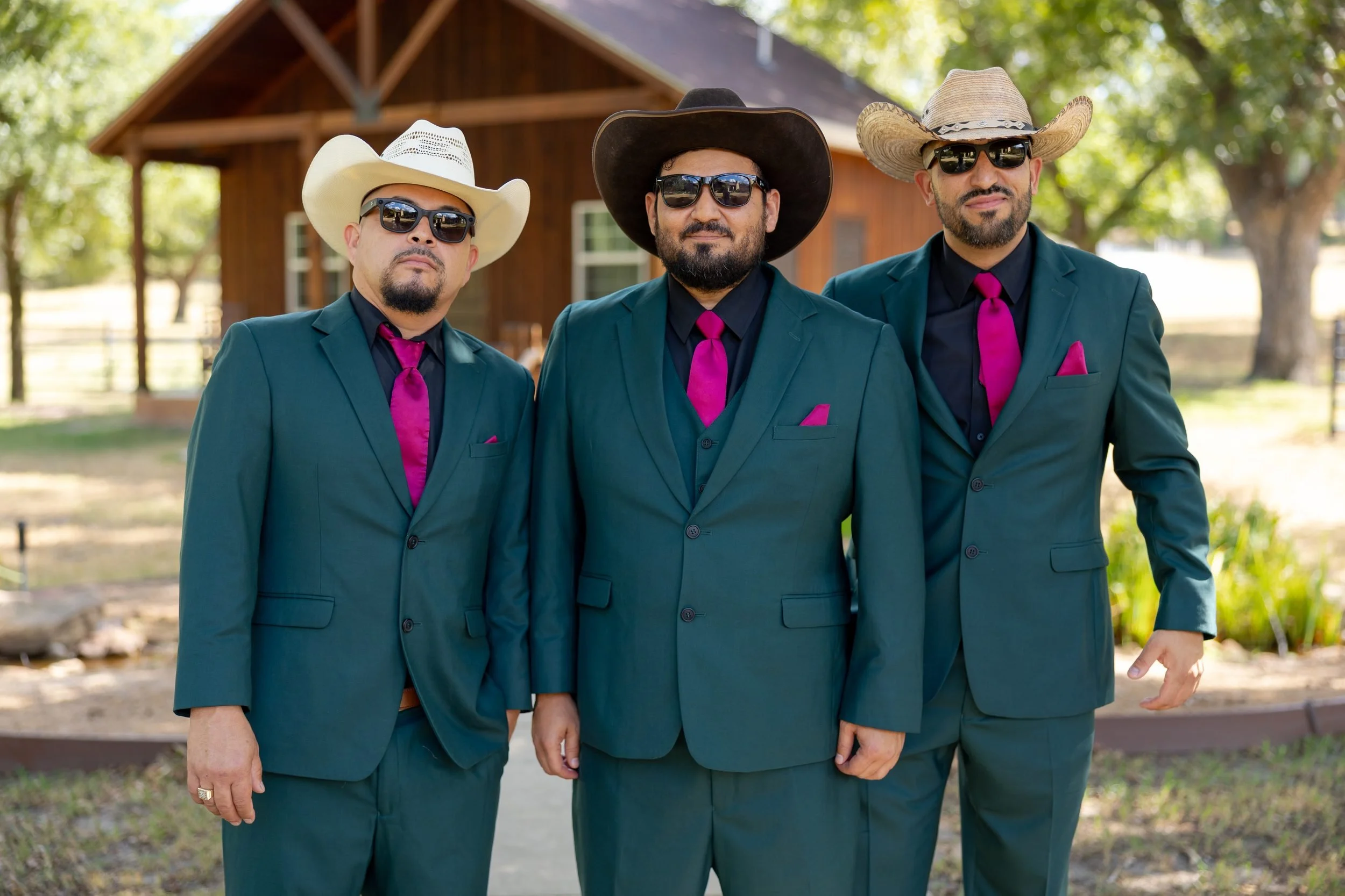 Groom and groomsmen in teal suits and cowboy hats at The Orchard in Azle