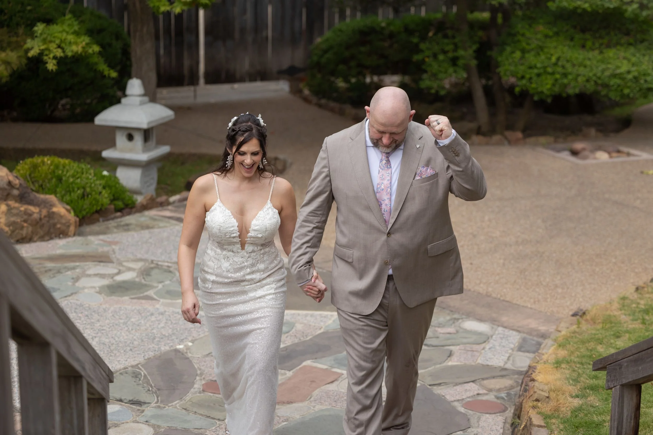 Newlyweds making their grand entrance at the Fort Worth Japanese Garden reception