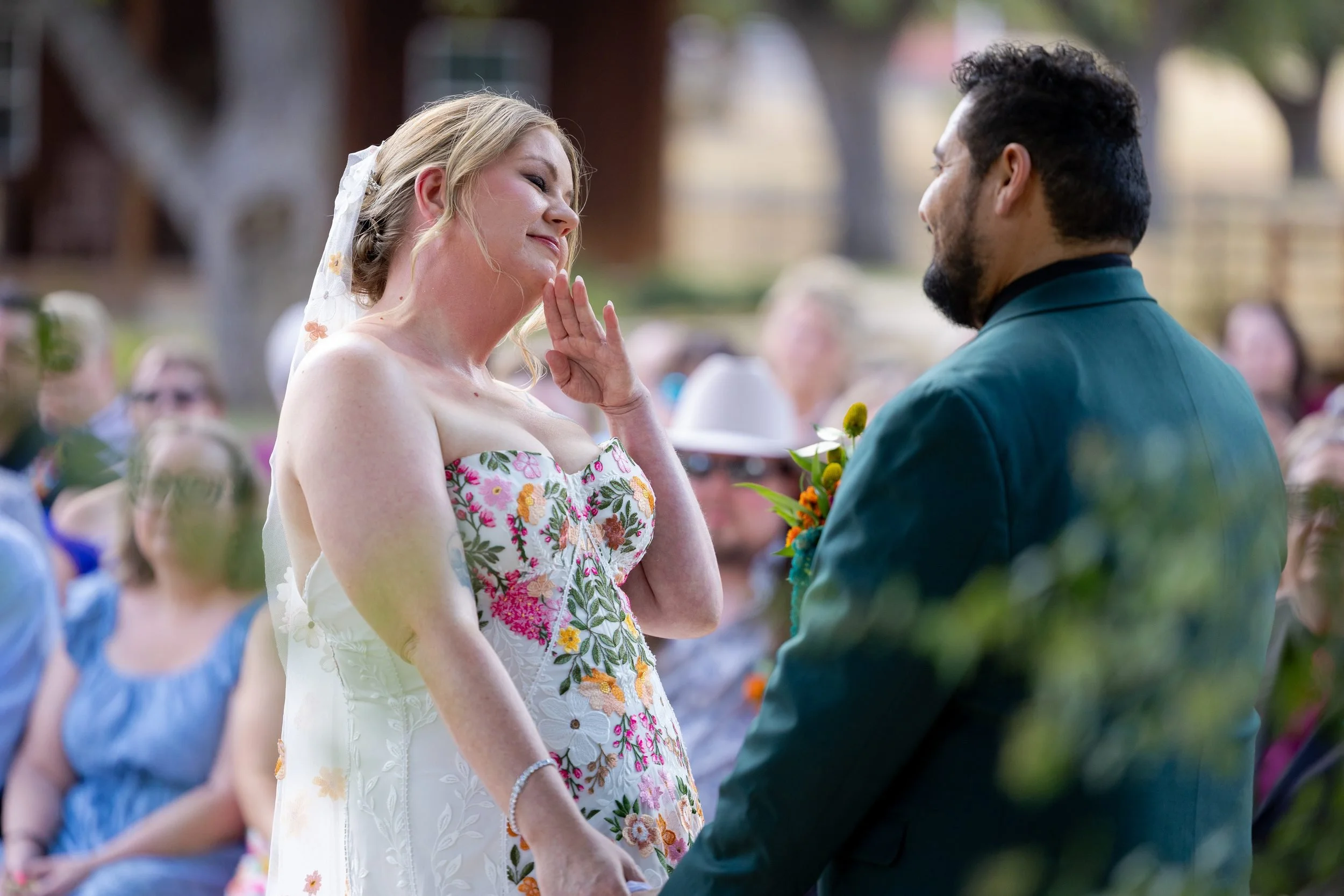 Carita and Miguel holding hands at the altar during their outdoor ceremony