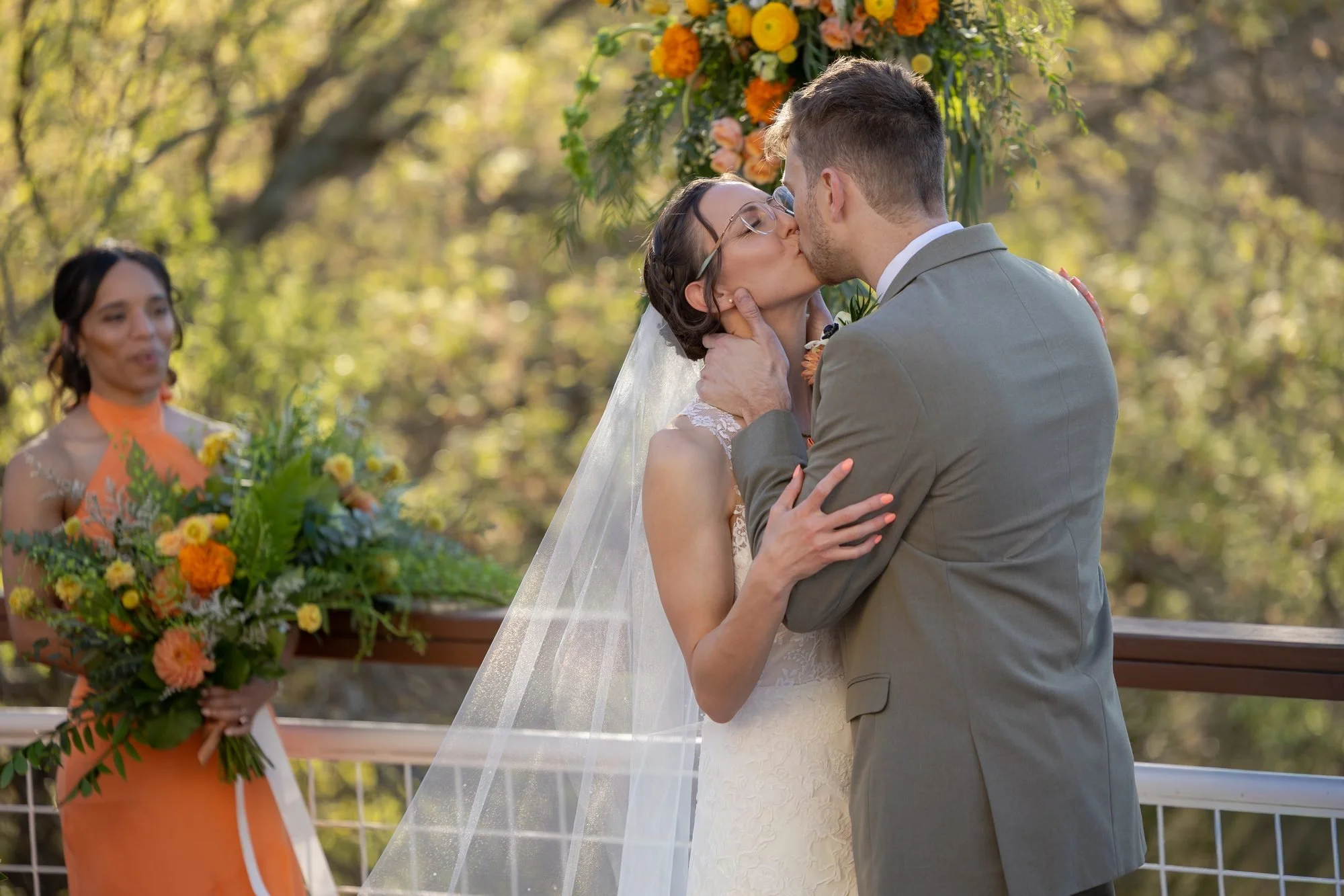Bride and groom share their first kiss at an outdoor Texas wedding ceremony