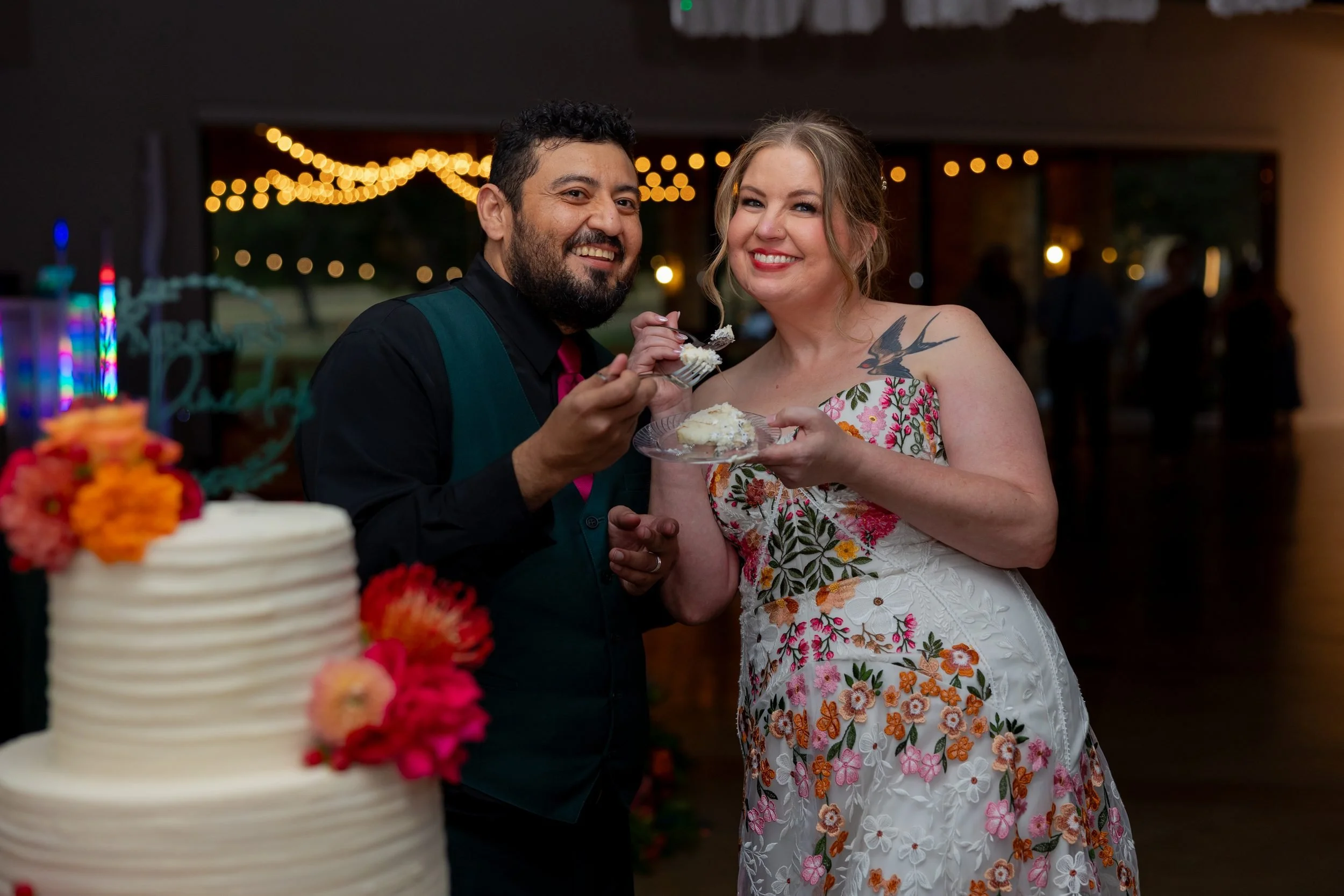 Carita and Miguel cutting their wedding cake at The Orchard reception
