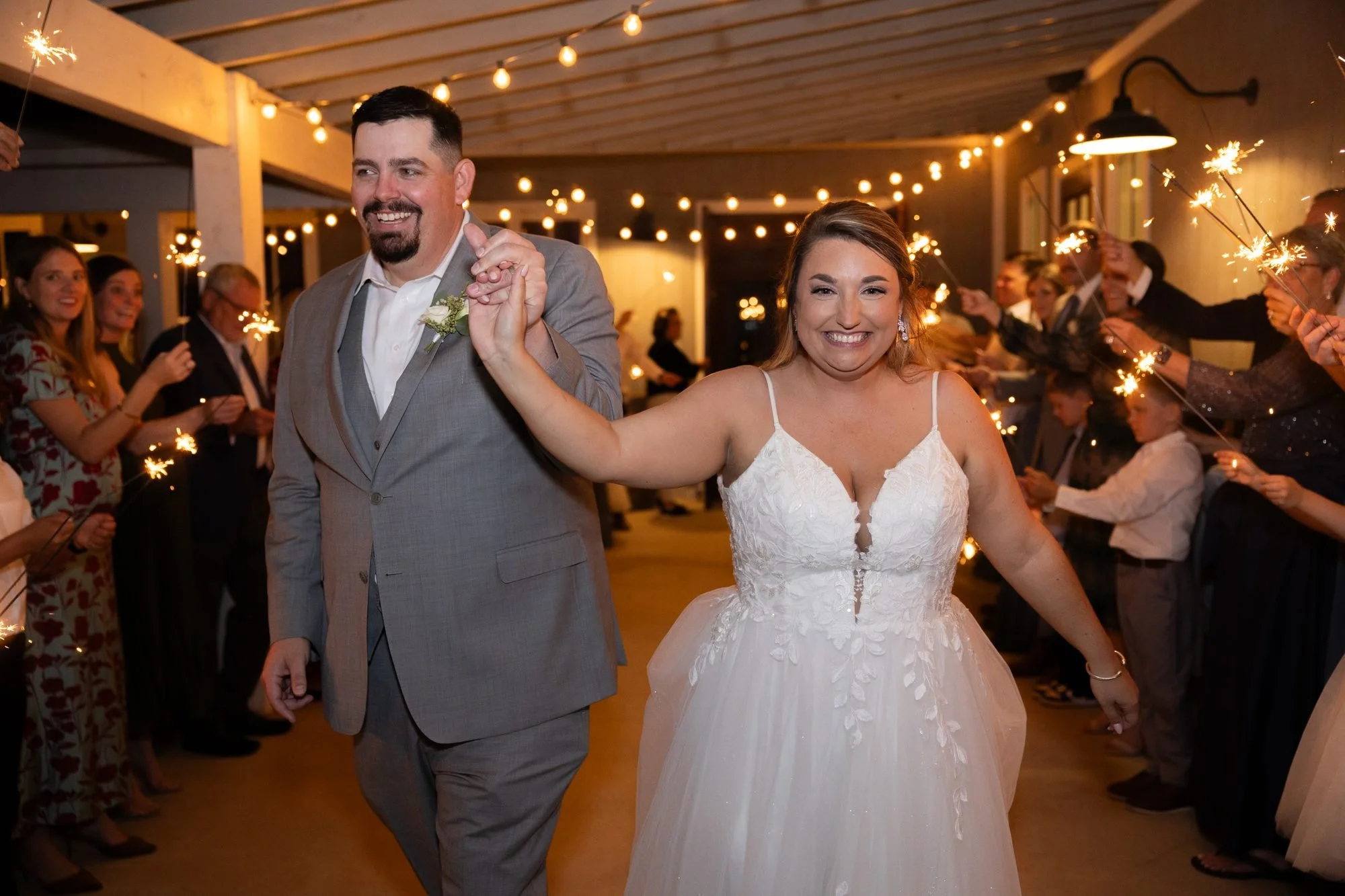 Bride and groom run through a sparkler exit at their DFW wedding