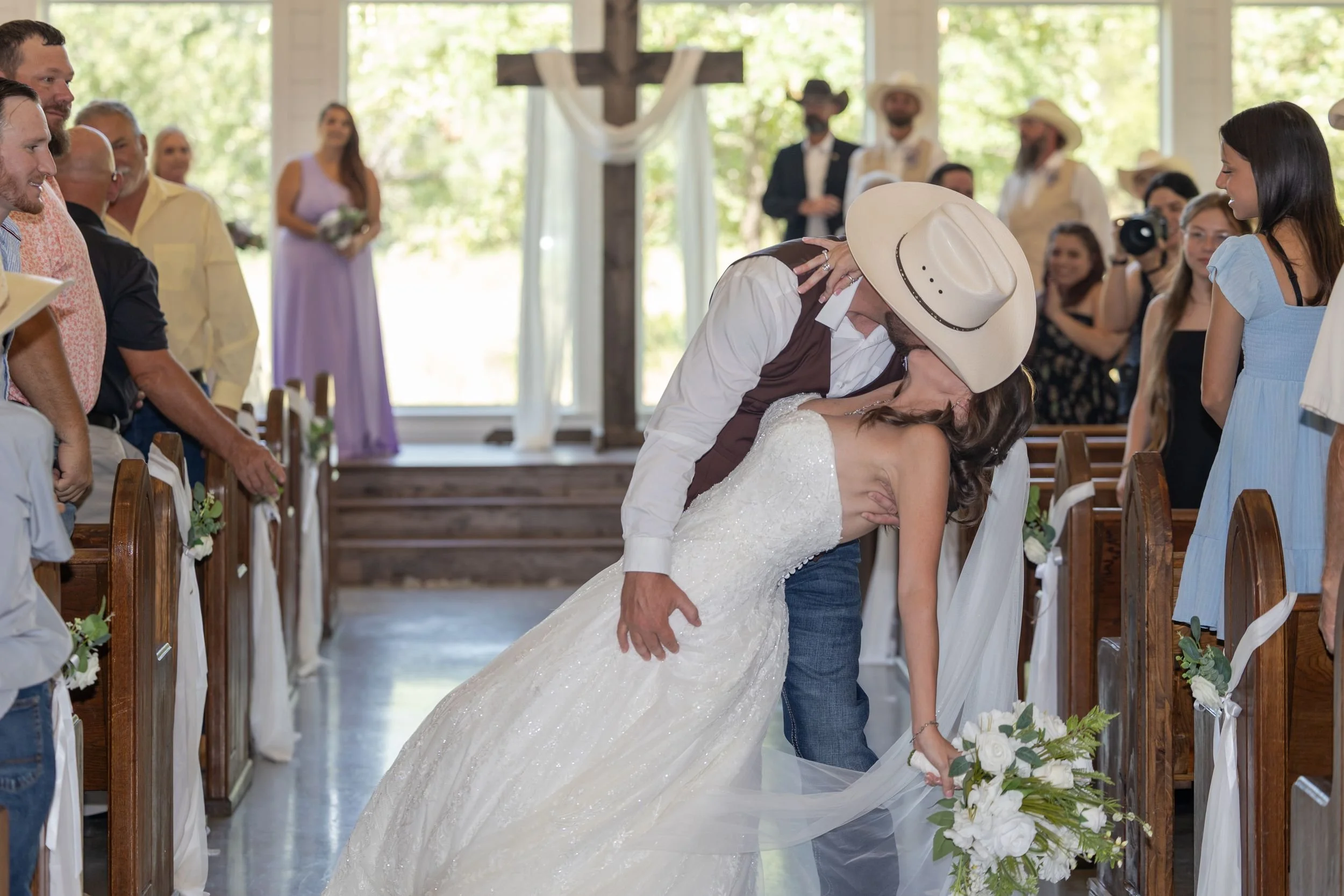 Heather and Geffrey's first kiss in the chapel at The Barn at Paradise Place