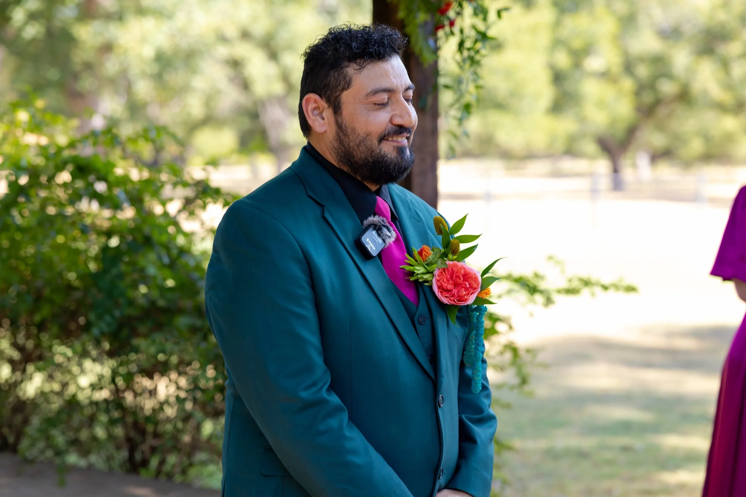 Miguel in a teal suit waiting for his bride at The Orchard in Azle