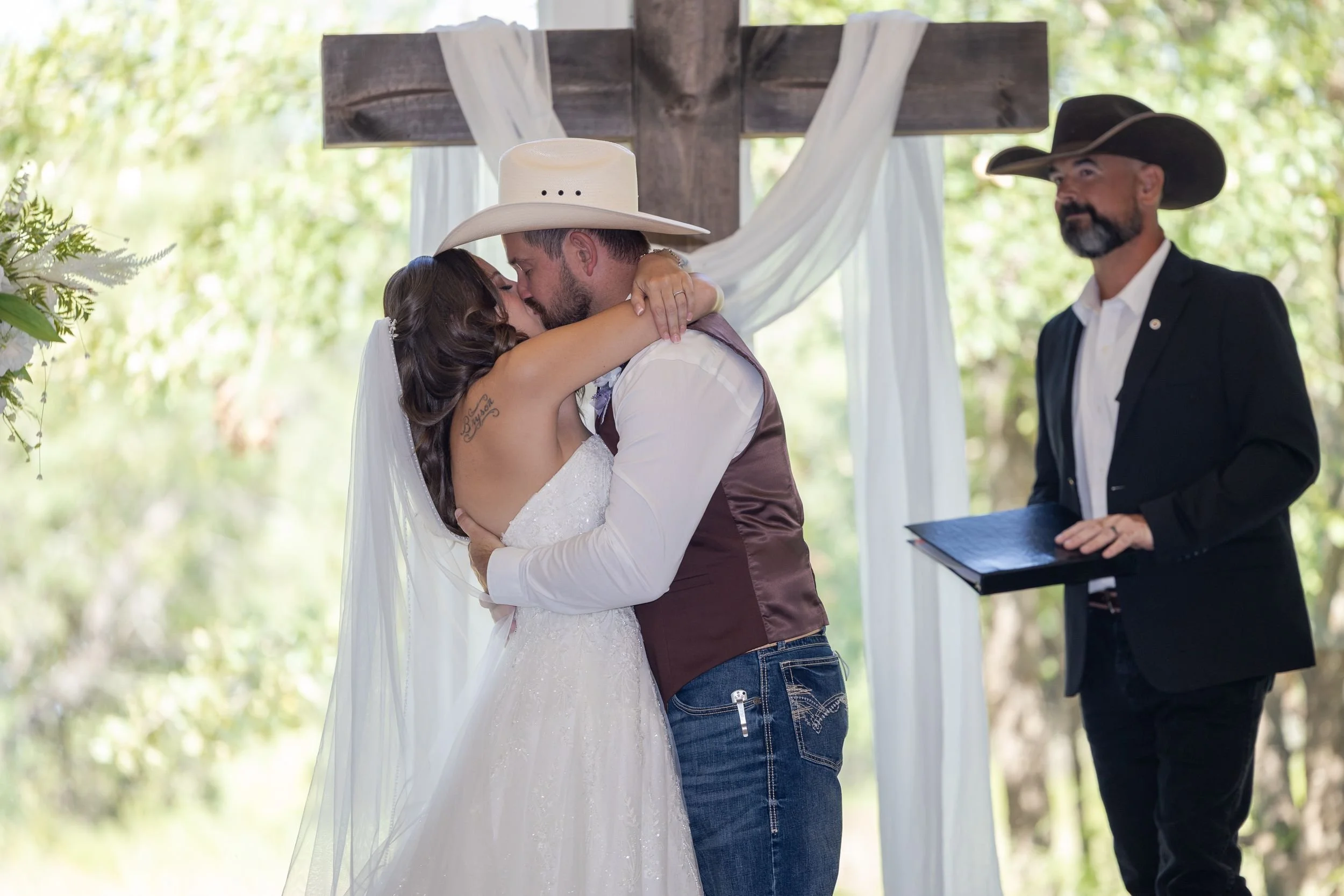 Heather and Geffrey embracing at the altar during their Weatherford wedding ceremony