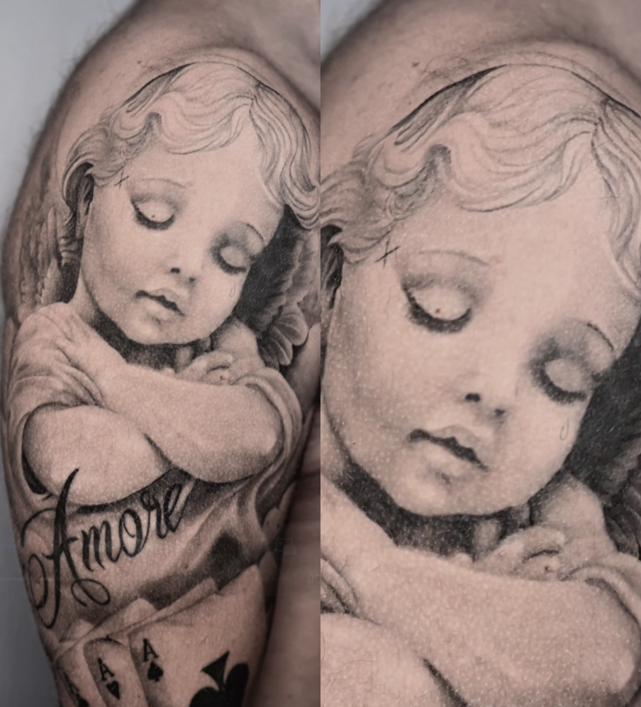 Black and gray tattoo of a young girl with her head slightly bowed, eyes closed, and arms crossed, with the word "Amor" written underneath and a set of four aces poker cards at the bottom. Explore American traditional tattoos at NEXT in Paris.
