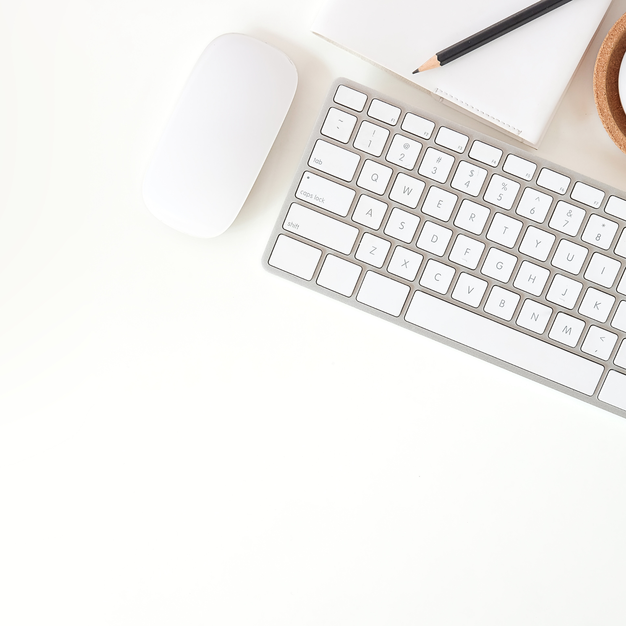 White flatlay keyboard background image behind tablet with therapist website templates rotating.