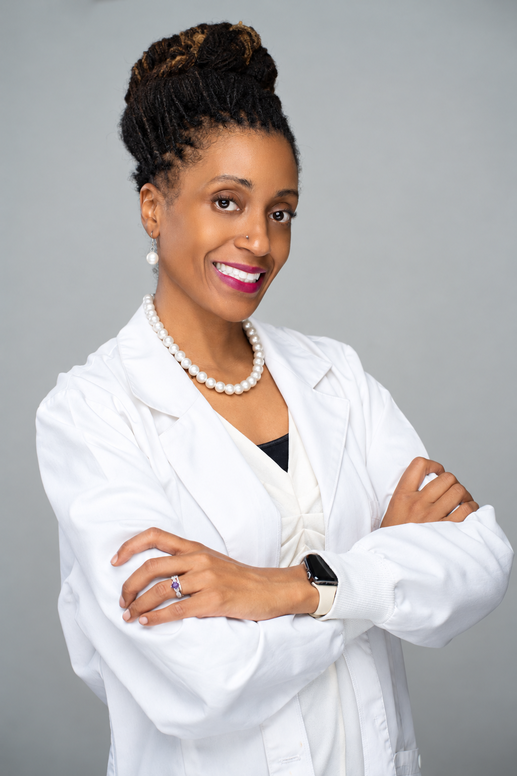 Dr. Sheniece L. Martin-Stancil-El, DNP, RN, CNL, Vice President of the home care organization, wearing a white lab coat.