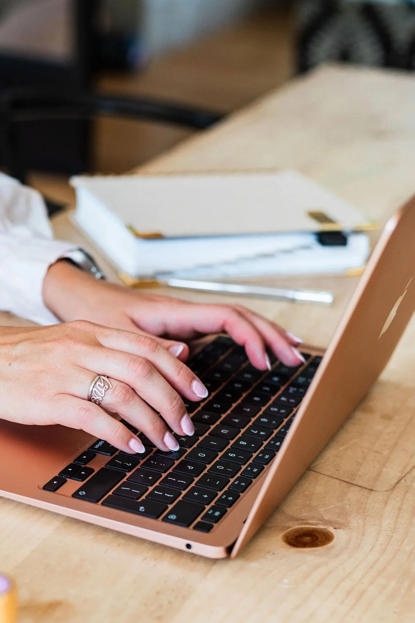 Close-up of Lee-Anne Burgess typing on a laptop.