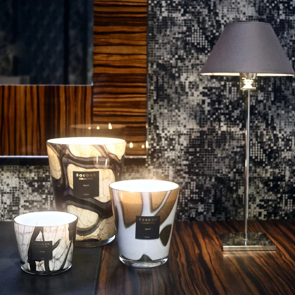 Baobab Collection candles glowing in a dark, elegant living room
