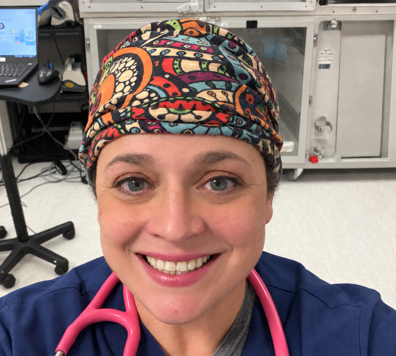 Rachel Poulin, founder of VetTech Explains, wearing scrubs and a pink stethoscope