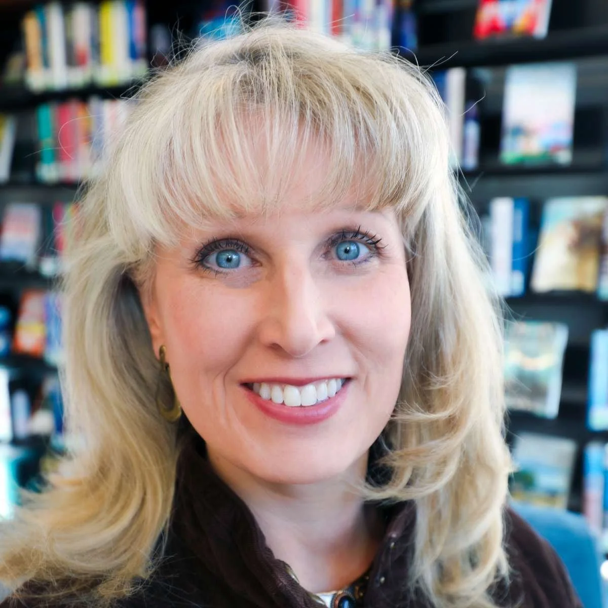 Adriane Herrick Juarez, Park City Library Director and artist, with blonde hair and blue eyes in a library.