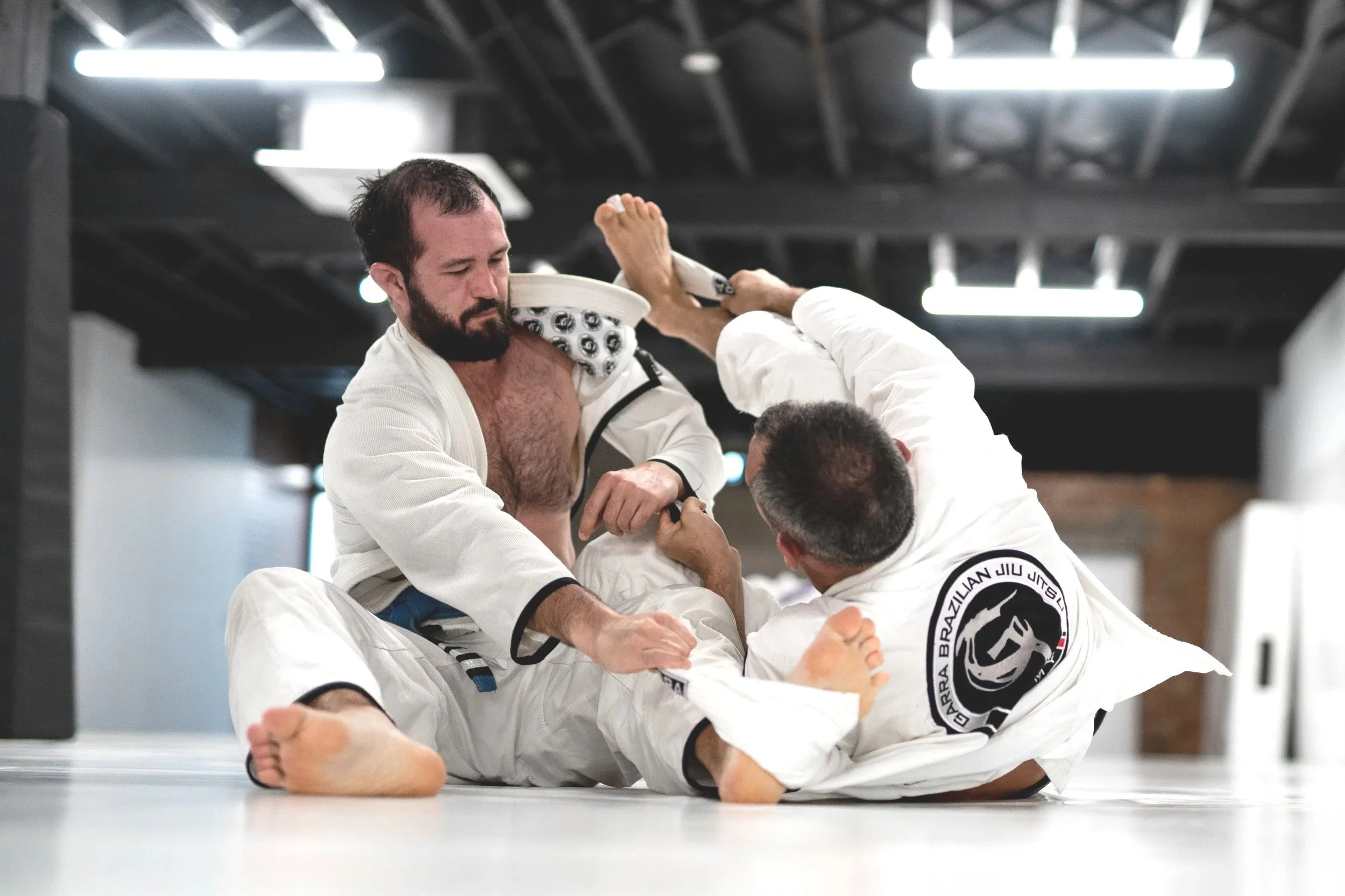 Training in the gi is a slower, more deliberate way to learn jiu-jitsu — and that's exactly what makes it so valuable. The collar, sleeves, and lapels give you grips, control, and a whole range of technical possibilities