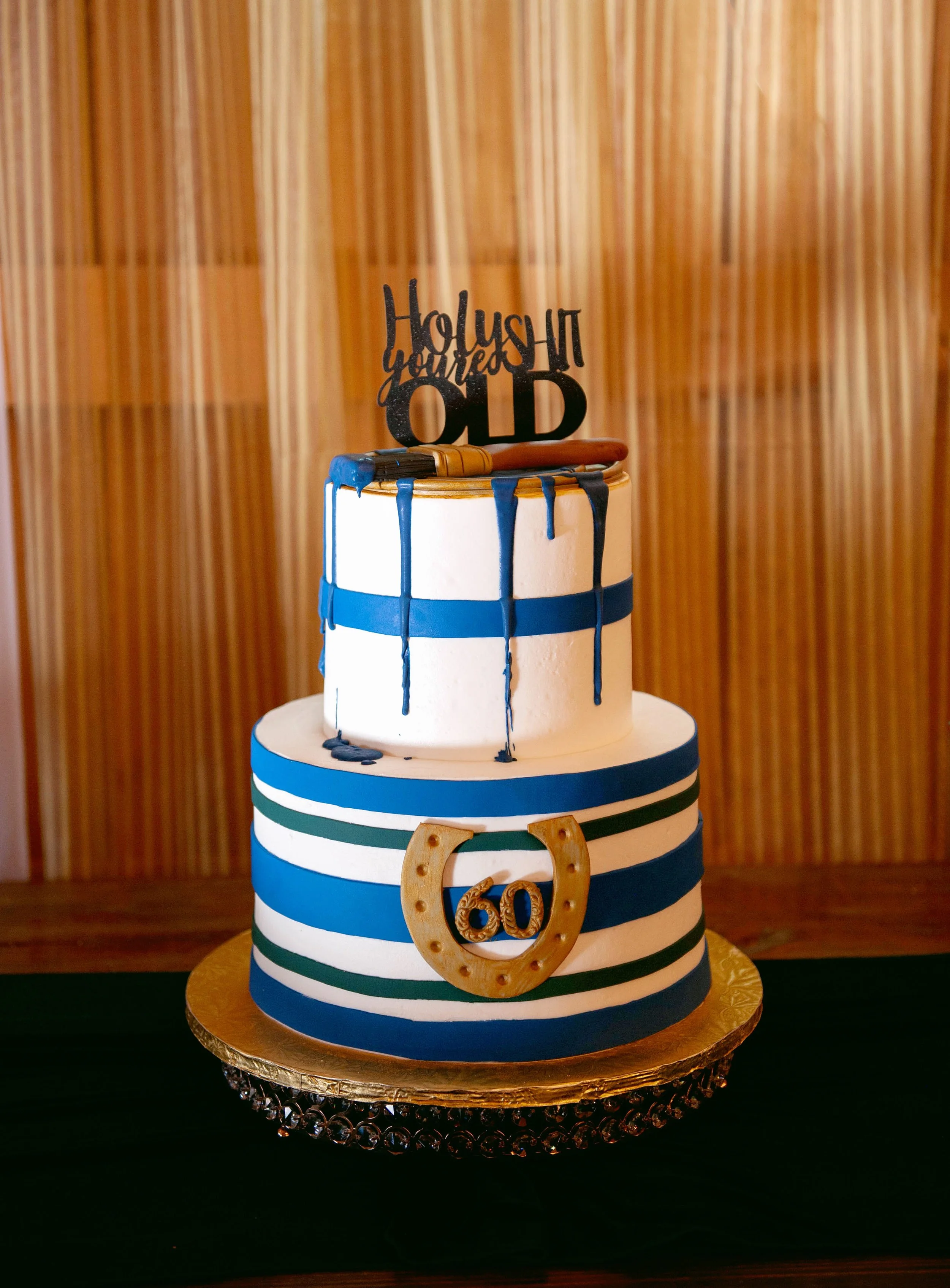 Custom 60th birthday cake with navy, emerald and gold details for an elegant milestone celebration.