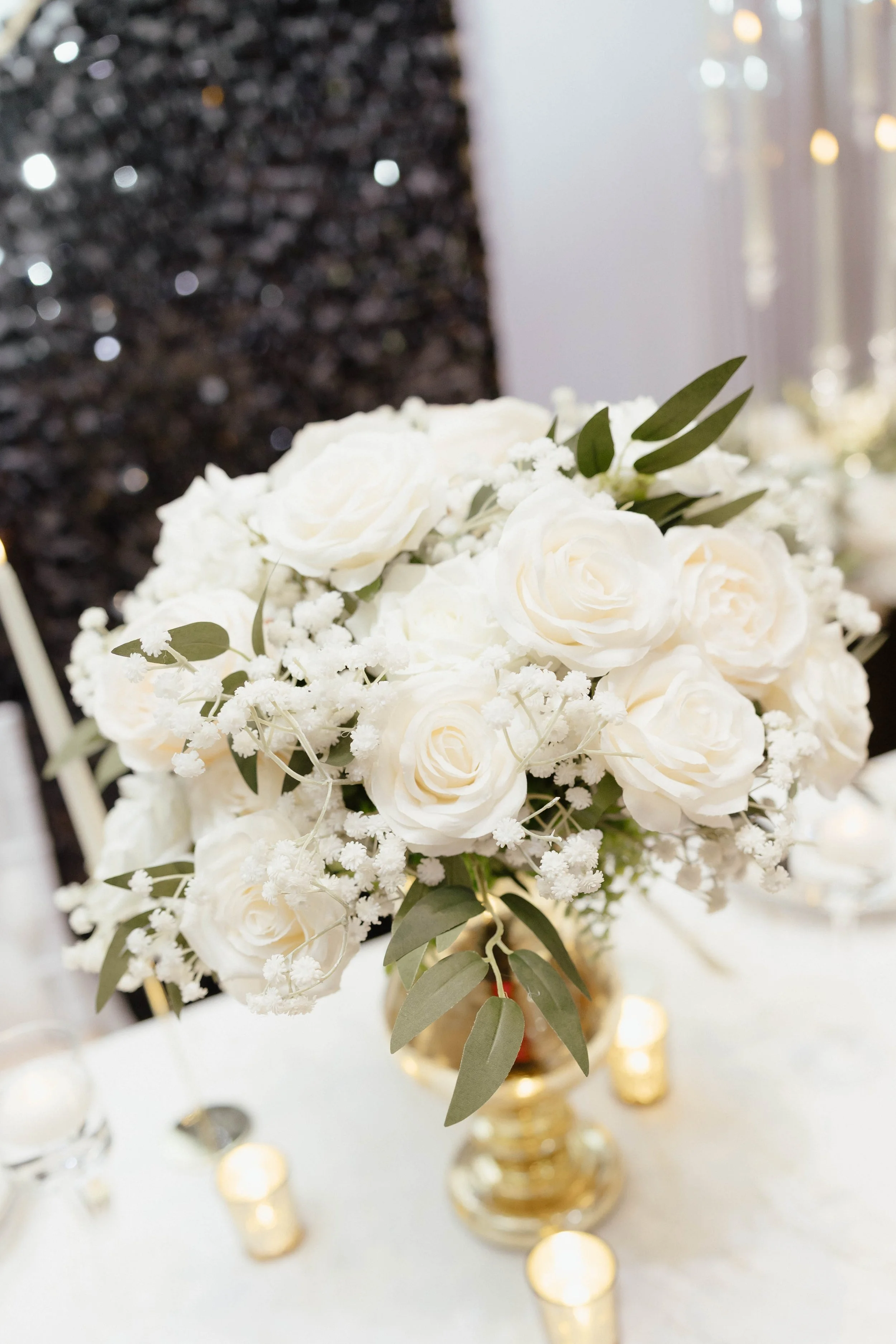 Elegant white bridal bouquet with roses and soft greenery.