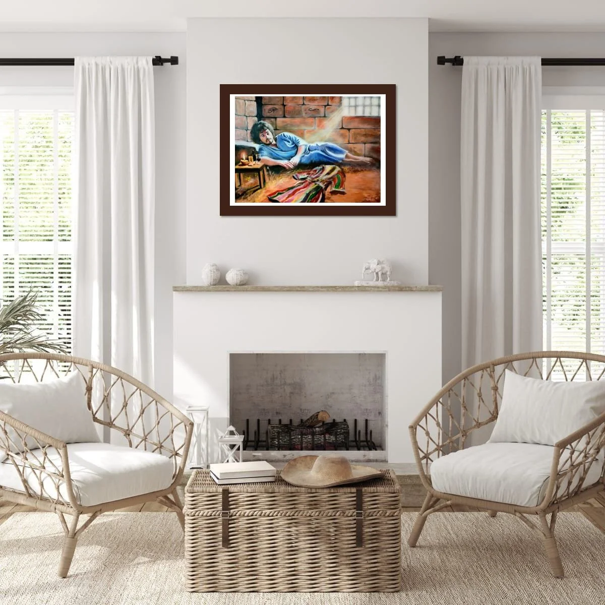 Living room with white walls and curtains, two rattan chairs with white cushions, a wicker coffee table with a hat and books, a fireplace, and a colorful painting of a woman in blue lounging on a brick wall.