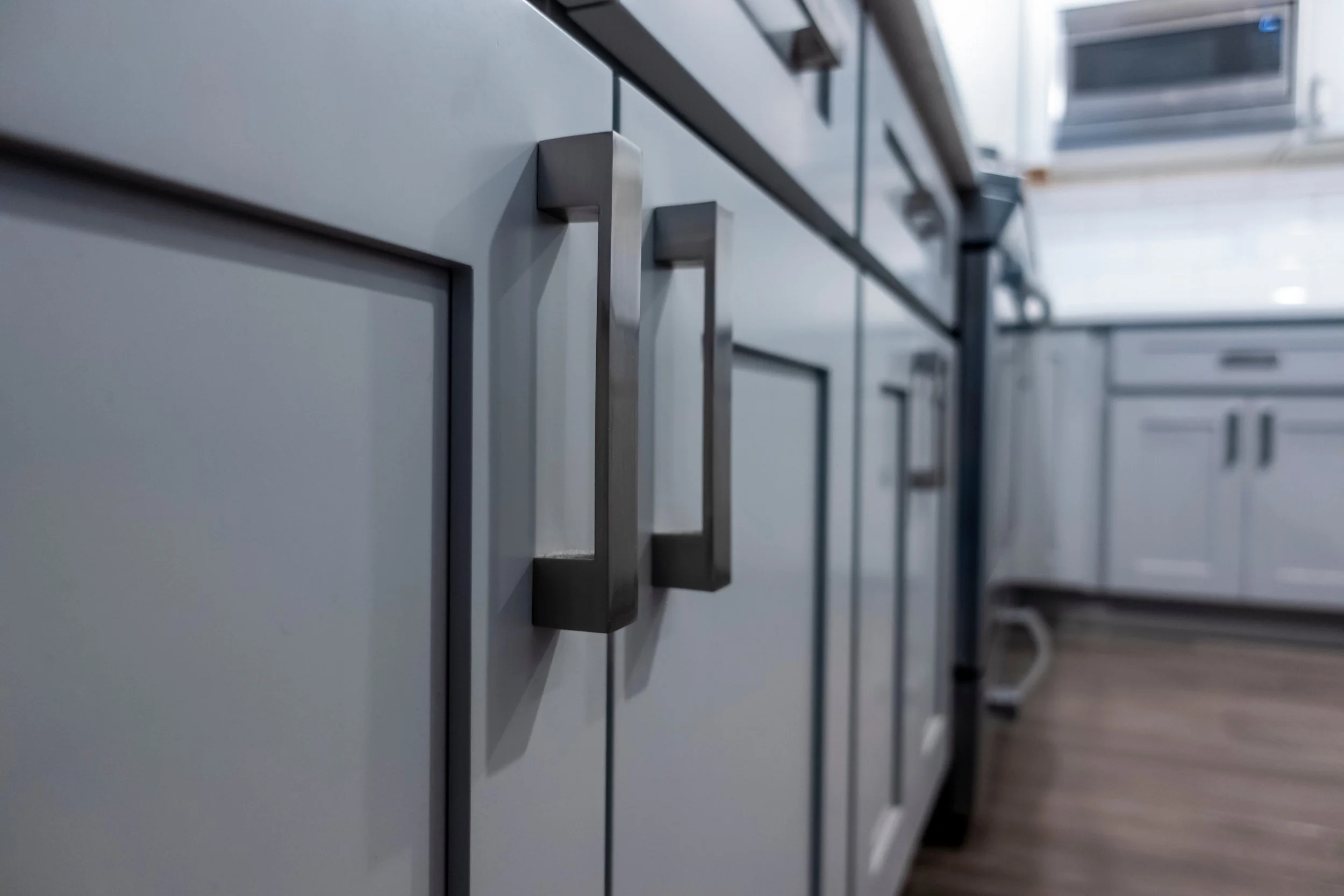 gray kitchen cabinet door with charcoal handles