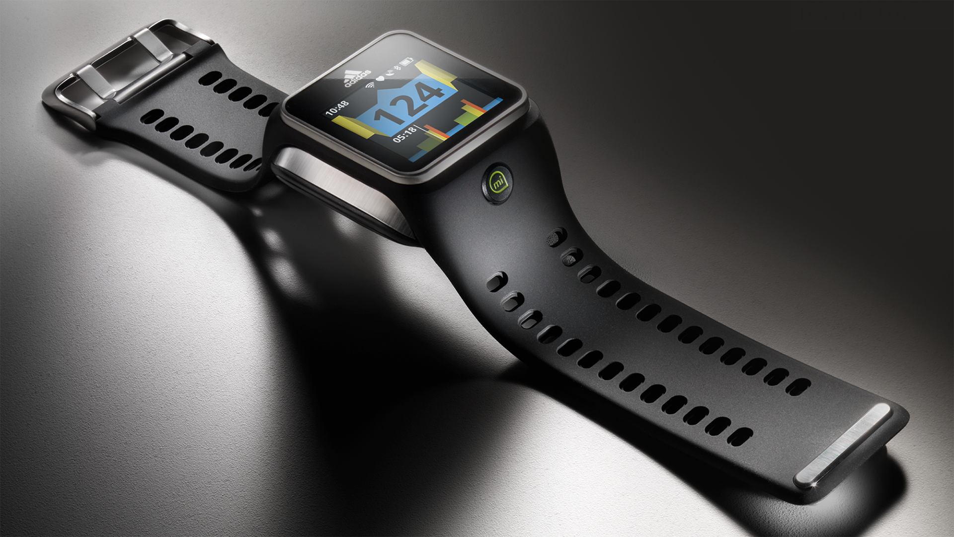 Close-up of an adidas black smartwatch with a sport band, displaying a colorful health and fitness chart on its screen for heart rate fitness tracking.