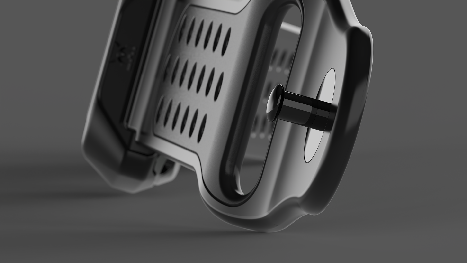 Close-up of a metallic electronic device with a circular button and a rectangular grill with multiple small holes, set against a gray background.