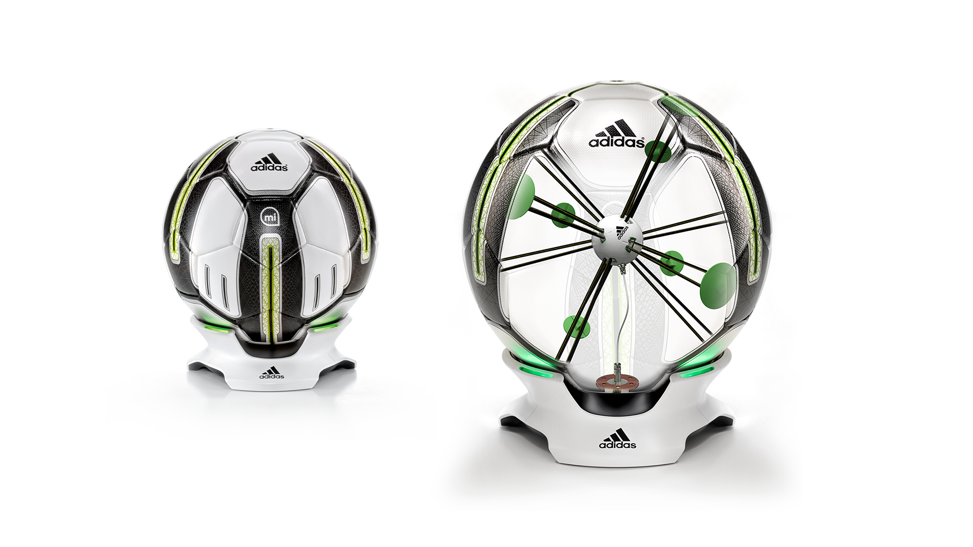 Two futuristic Adidas soccer balls, one in front with internal structure and sensors visible, and one in back with lines and green markings indicating internal components or data points, set against a plain white background.