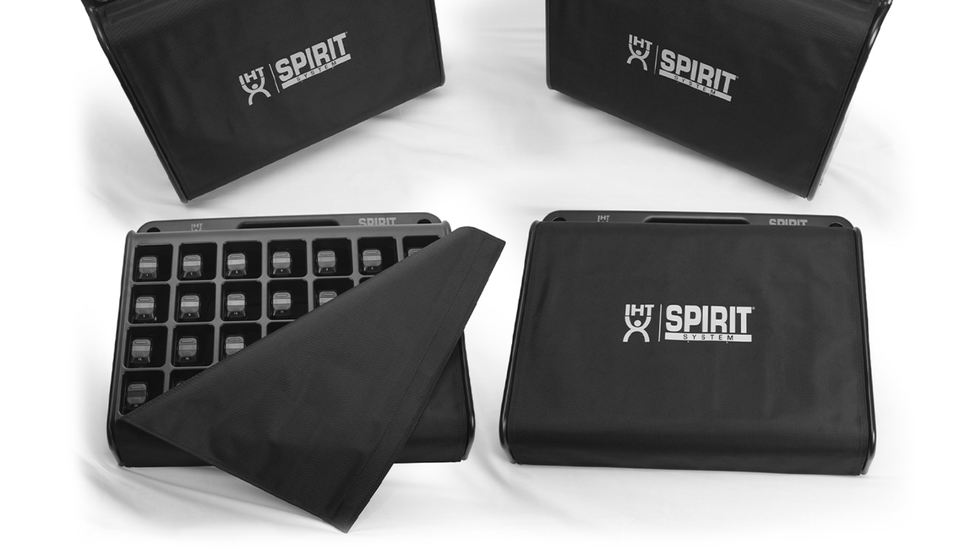 Set of black foam charging cases and tile racks with the logo 'IHT Spirit System' on the packaging, used for building custom workout platforms or flooring.