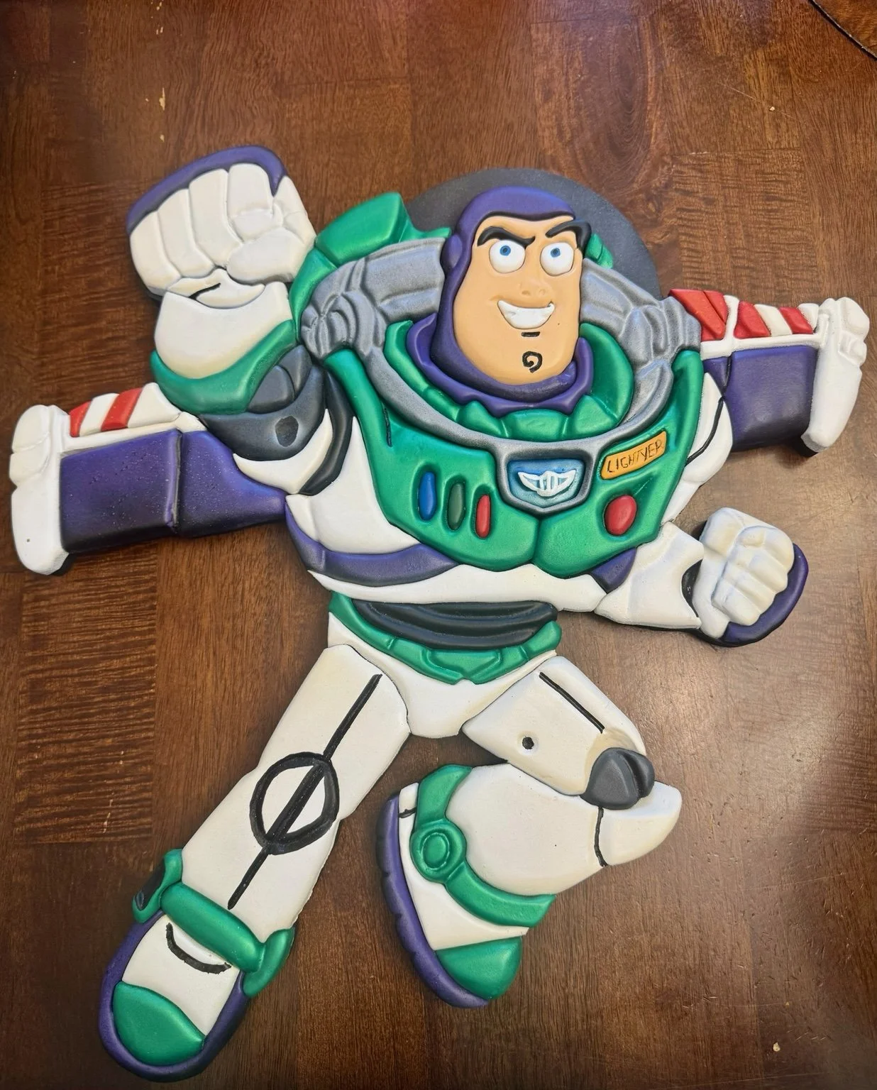 Handcrafted wooden Buzz Lightyear decorative wall art with colorful dimensional details.