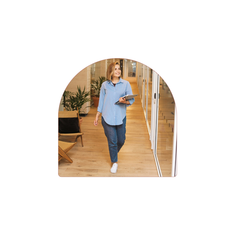 Psychologist the practice with her tablet in hand, smiling and relaxed set as her VA set up Halaxy automations for Medicare claiming, invoices and reminders