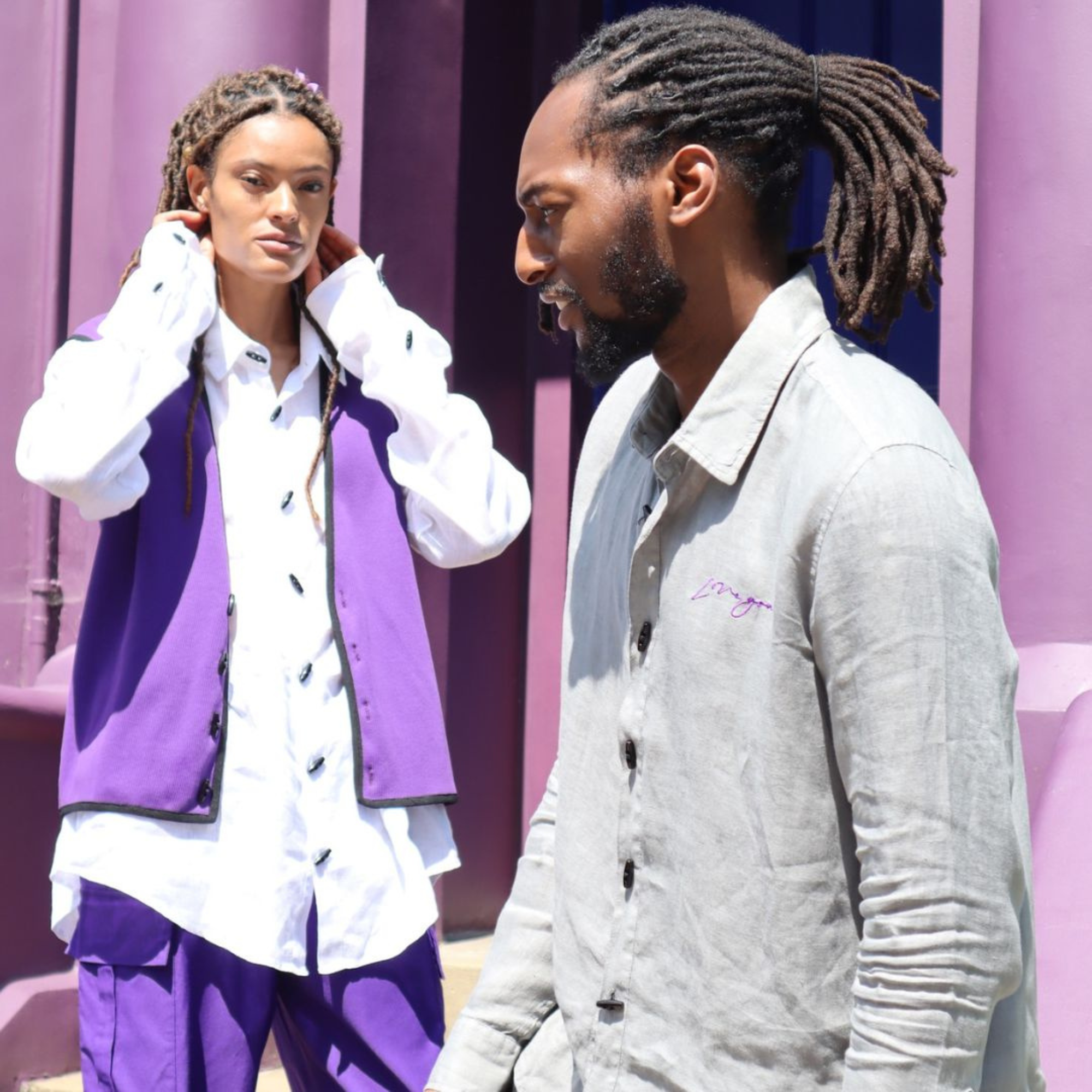 Two models wearing CGT Love You purple and grey looks beside a river