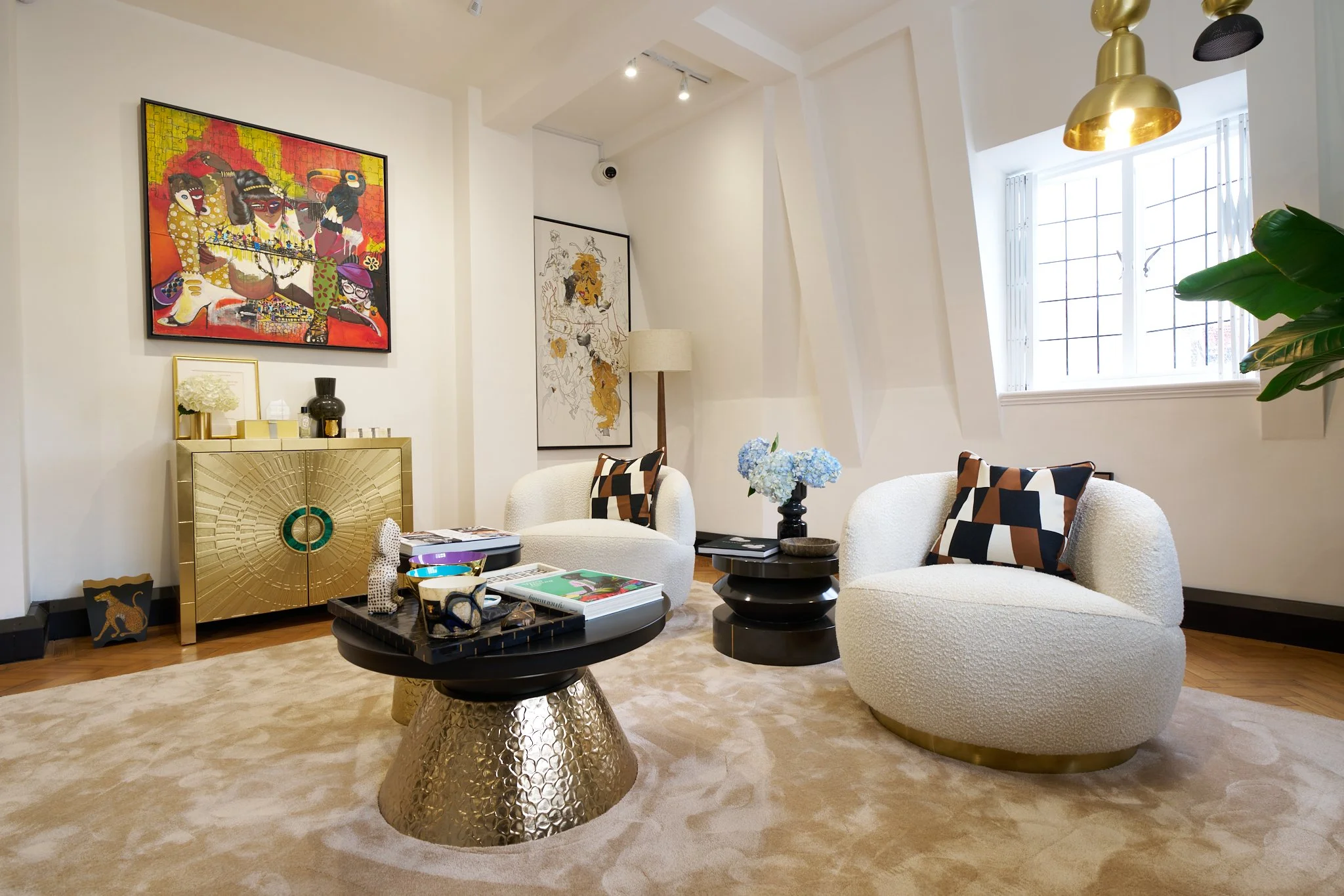 Wide view of the Matturi boutique with curved seating, artwork and jewellery displays
